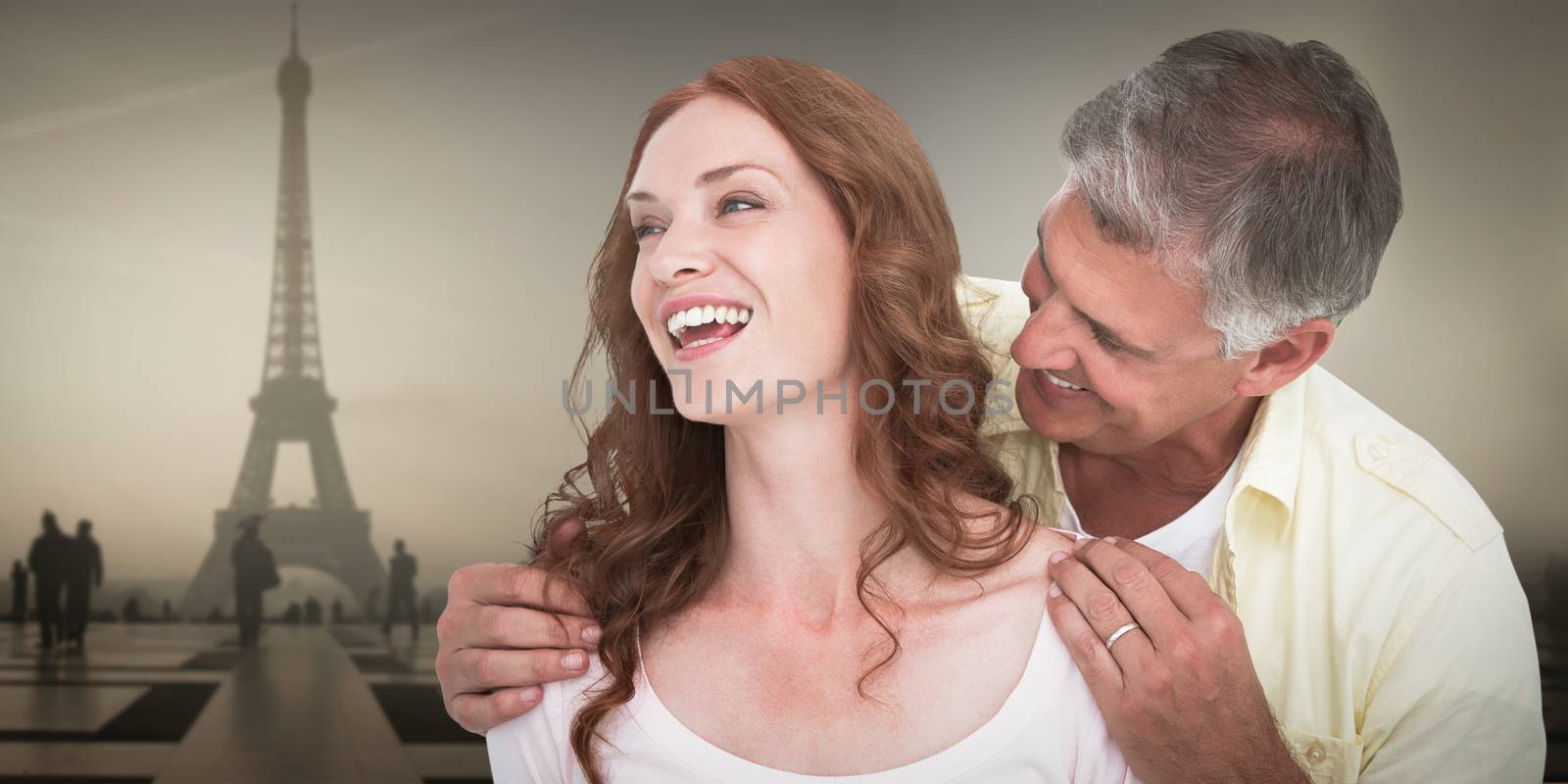 Casual couple laughing together against eiffel tower