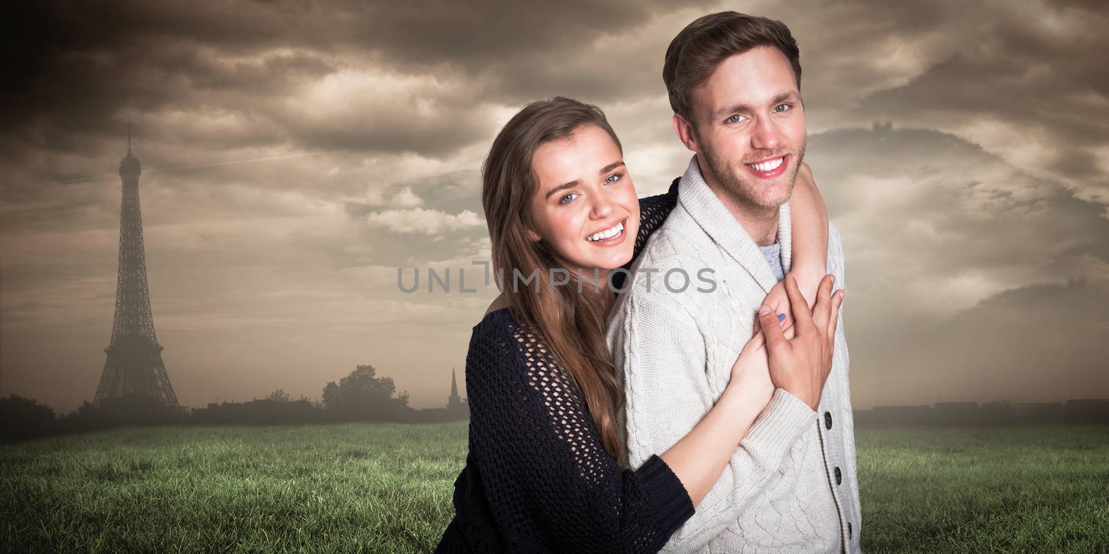 Portrait of happy young couple against paris under cloudy sky