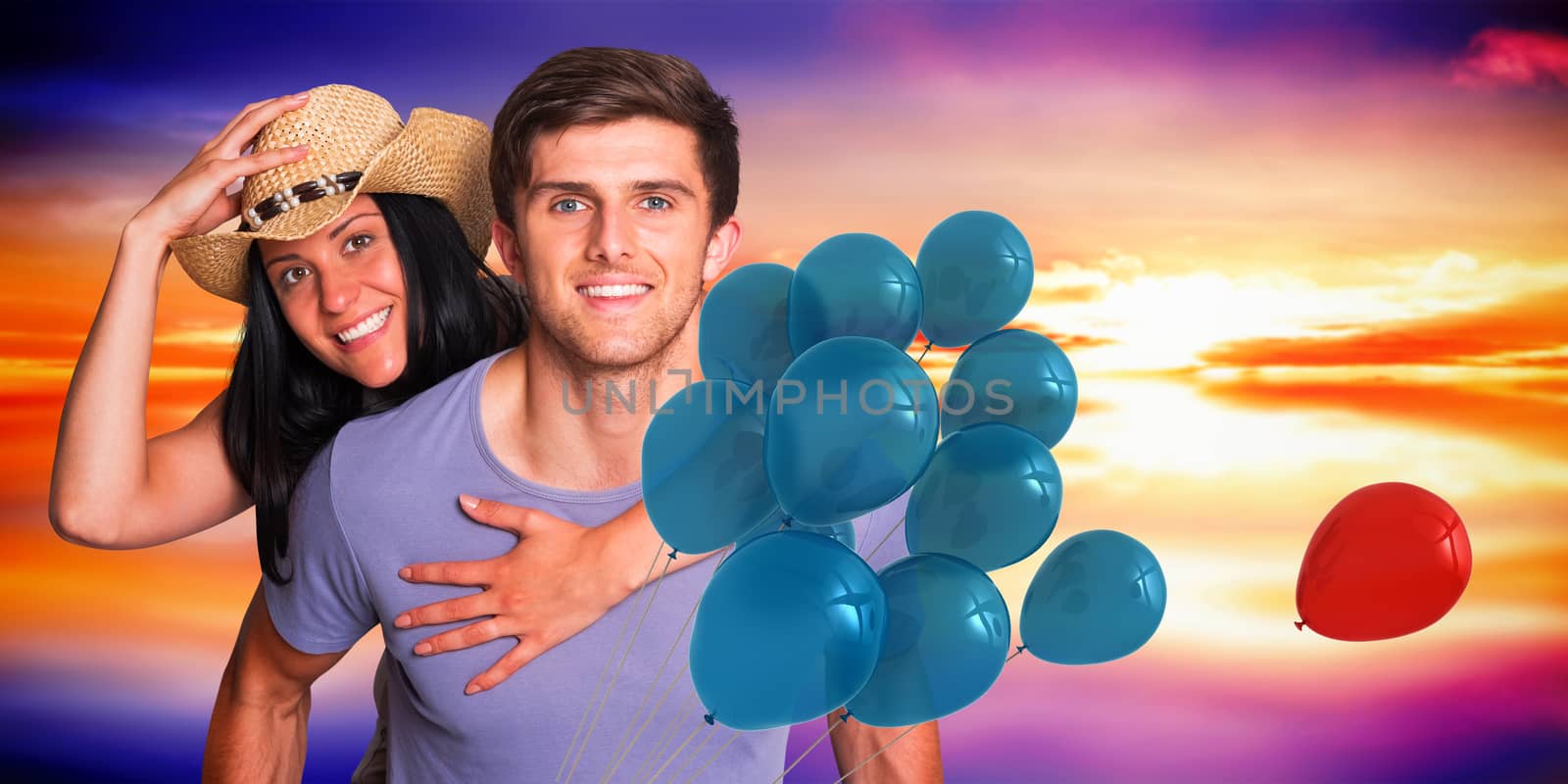 Man giving his pretty girlfriend a piggy back against purple sky with orange clouds