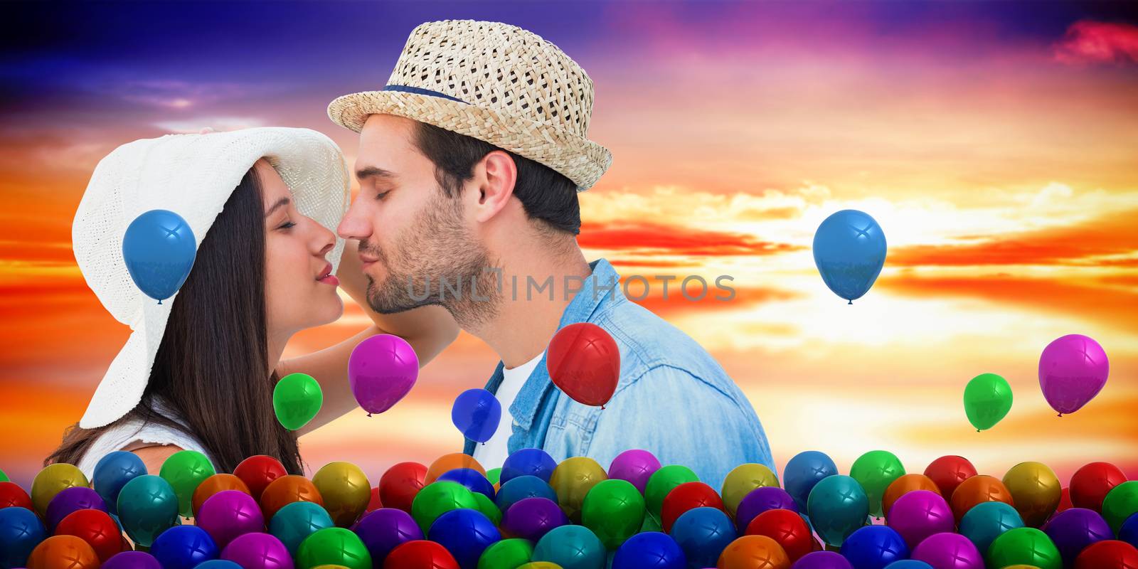 Happy hipster couple about to kiss against purple sky with orange clouds