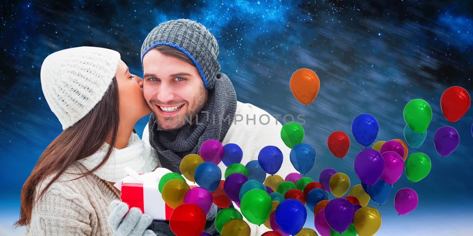 Winter couple holding gift against aurora night sky in blue