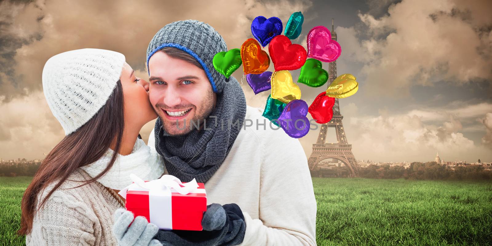 Winter couple holding gift against paris under cloudy sky