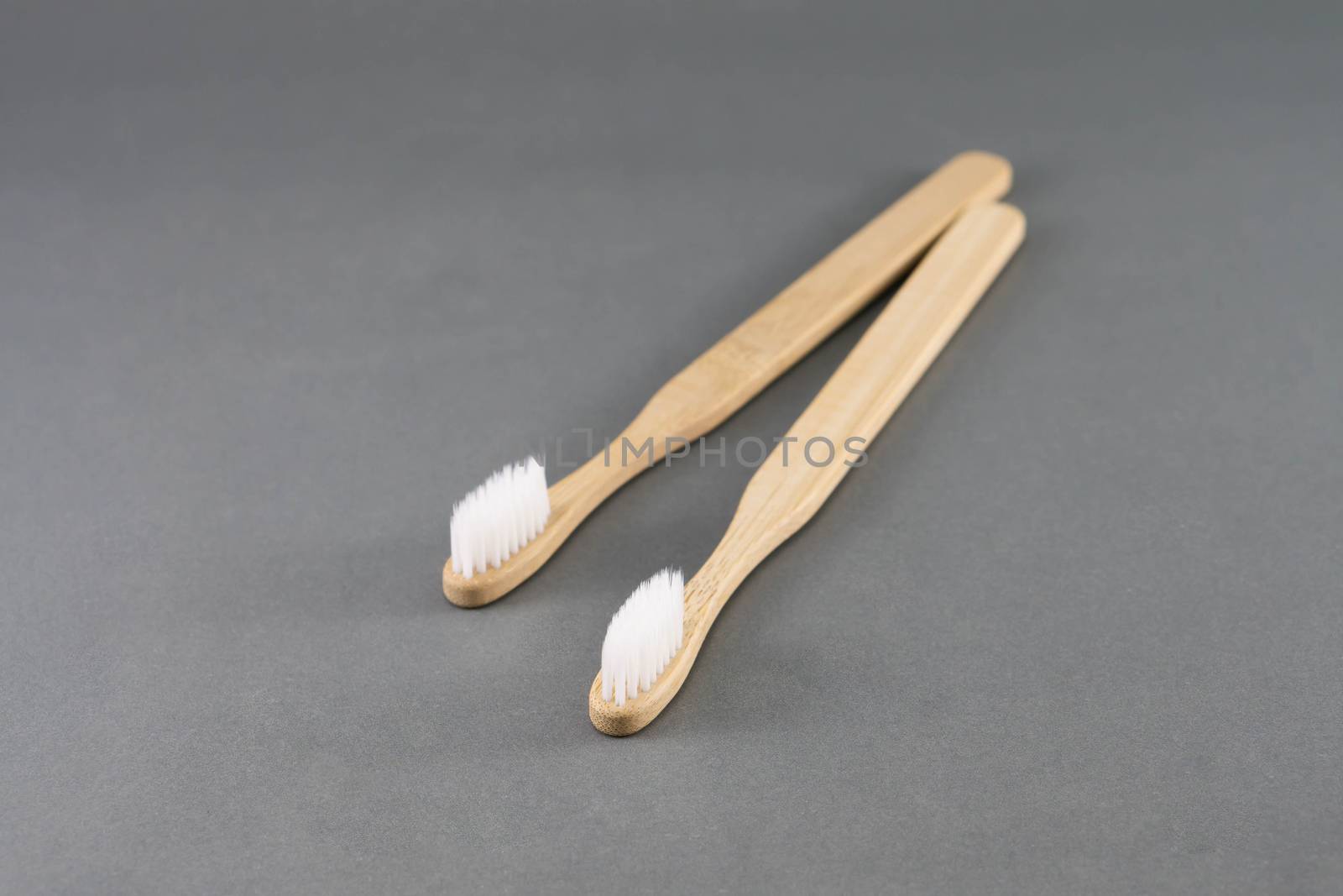 Close up wooden toothbrush on grey background, selective focus