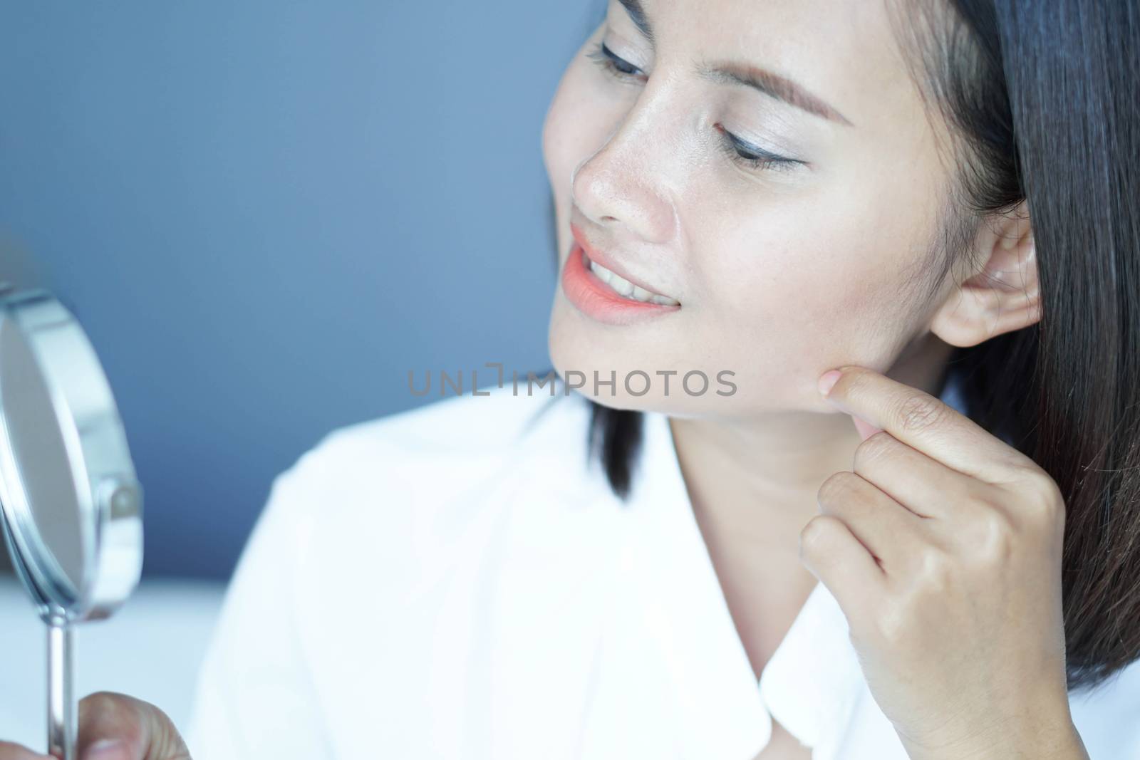 Close up face of woman looking the mirror with happy feeling, health care and beauty concept