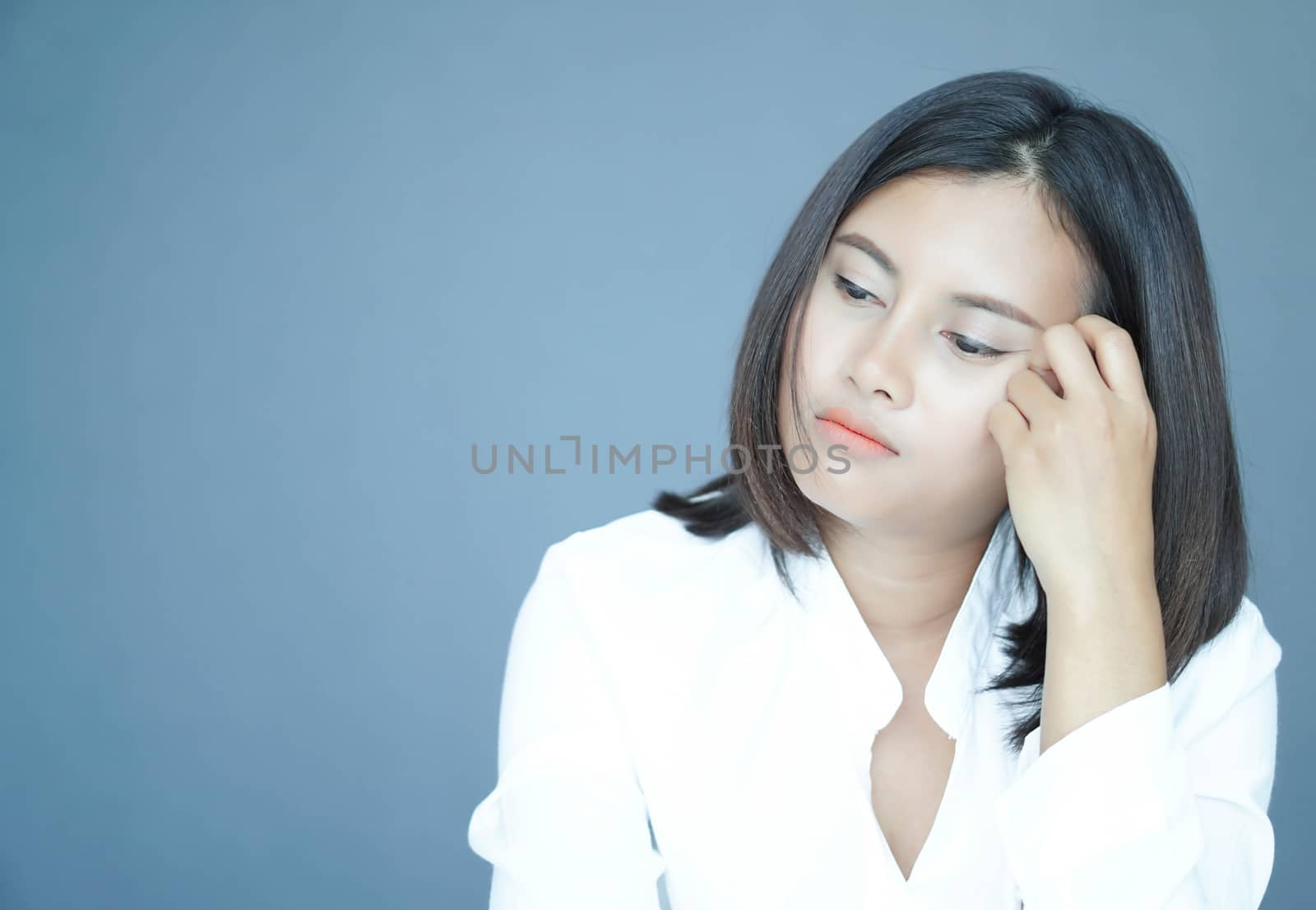 Closeup woman sitting on bed in the bedroom with thinking or depressed feeling, selective focus