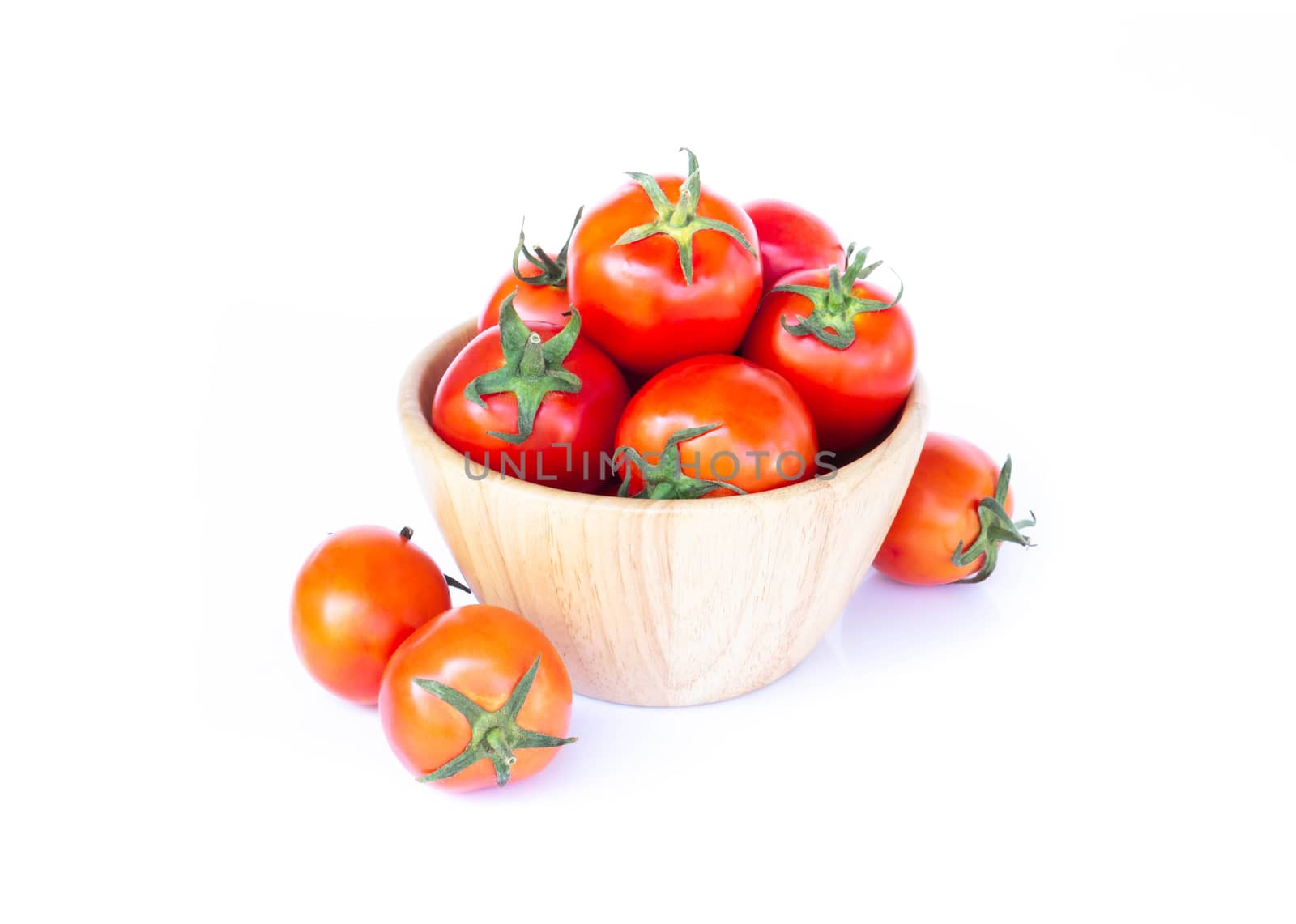 Fresh red cherry tomatoes in wood bowl, selective focus