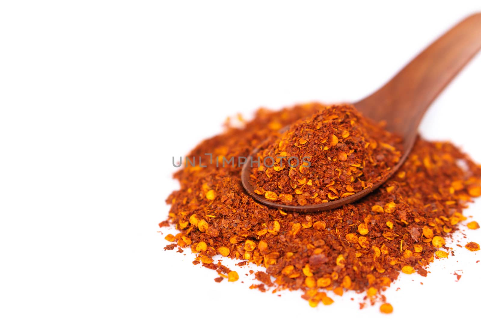 Red chilli powder in wood spoon on white background, food ingredient