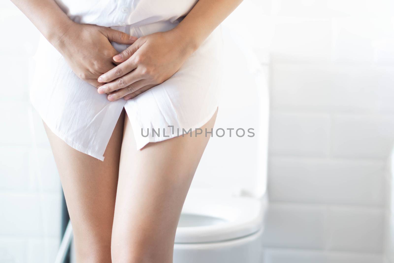 Close up woman stomachache with toilet in the morning, health care concept, selective focus