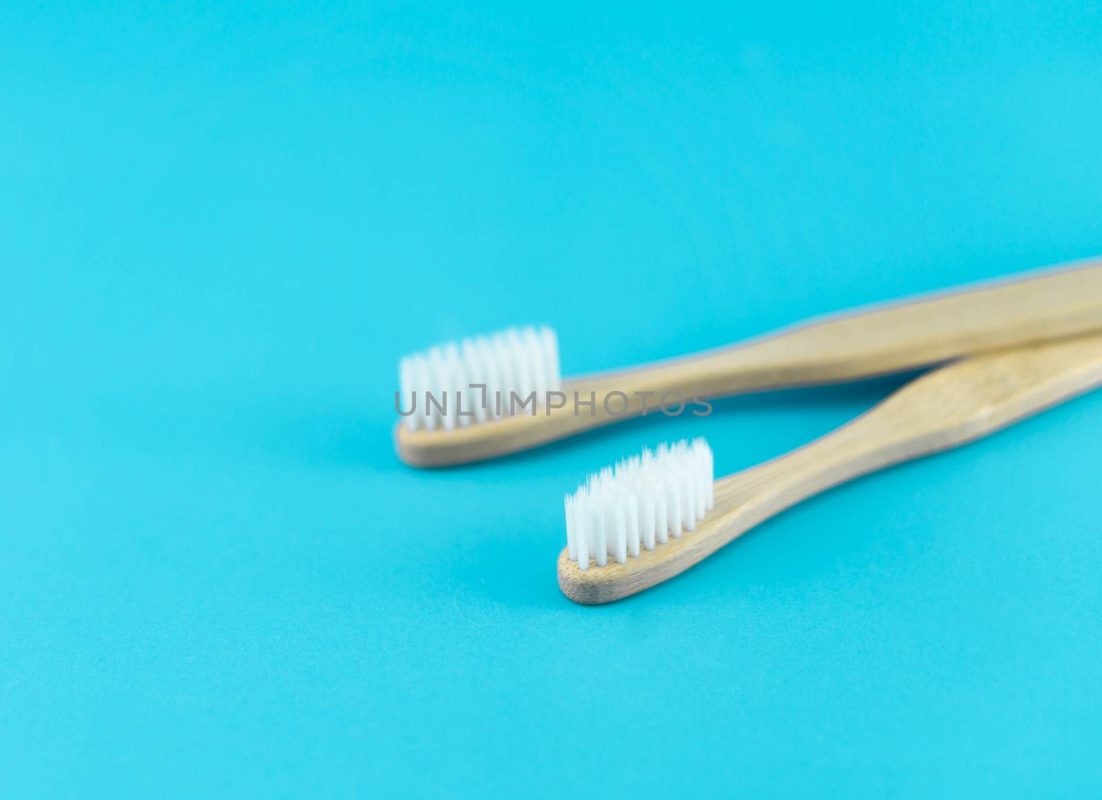 Close up wooden toothbrush on blue background, selective focus