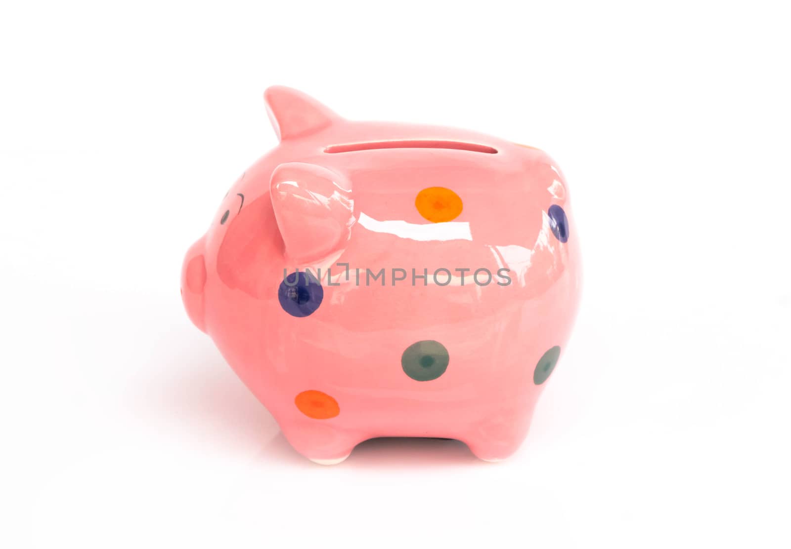 Pink ceramic piggy bank on white background, saving money concept