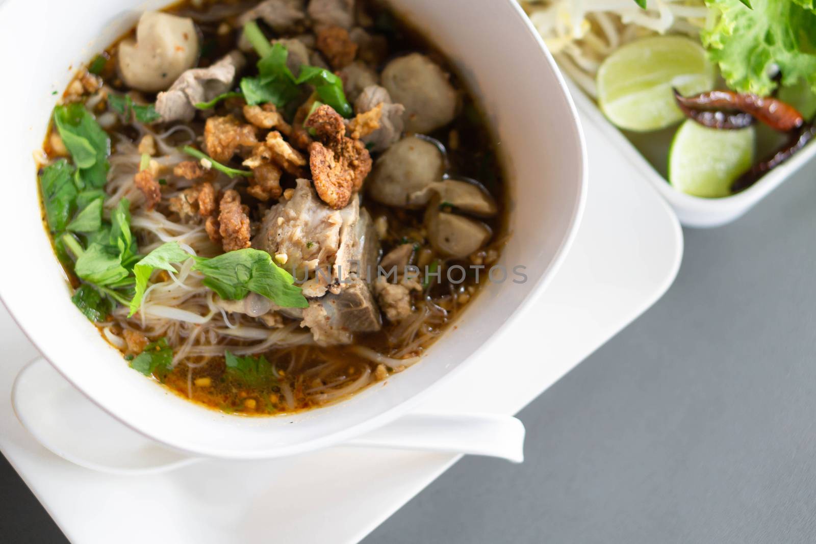Rice noodle soup with Cooked Liver in  bowl on table, selective focus
