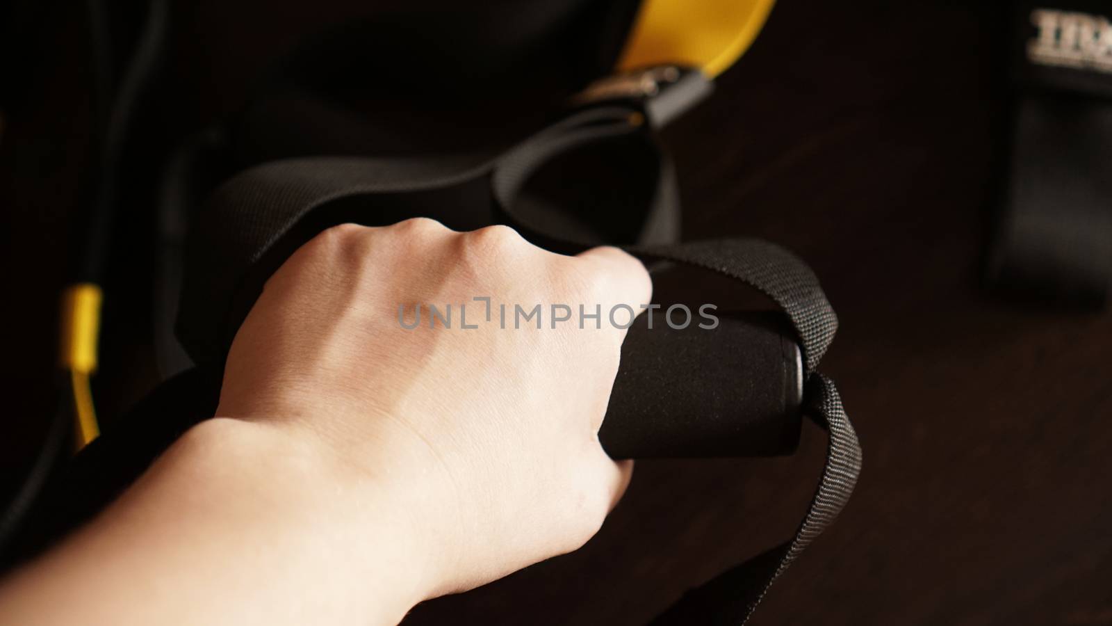 Close up on hands doing suspension training - sport at home