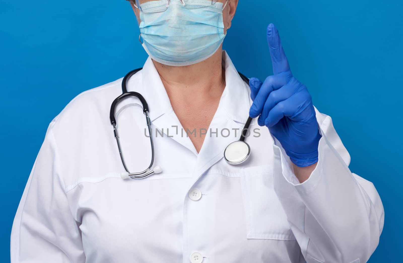 female doctor raised the index finger of his left hand, attentio by ndanko