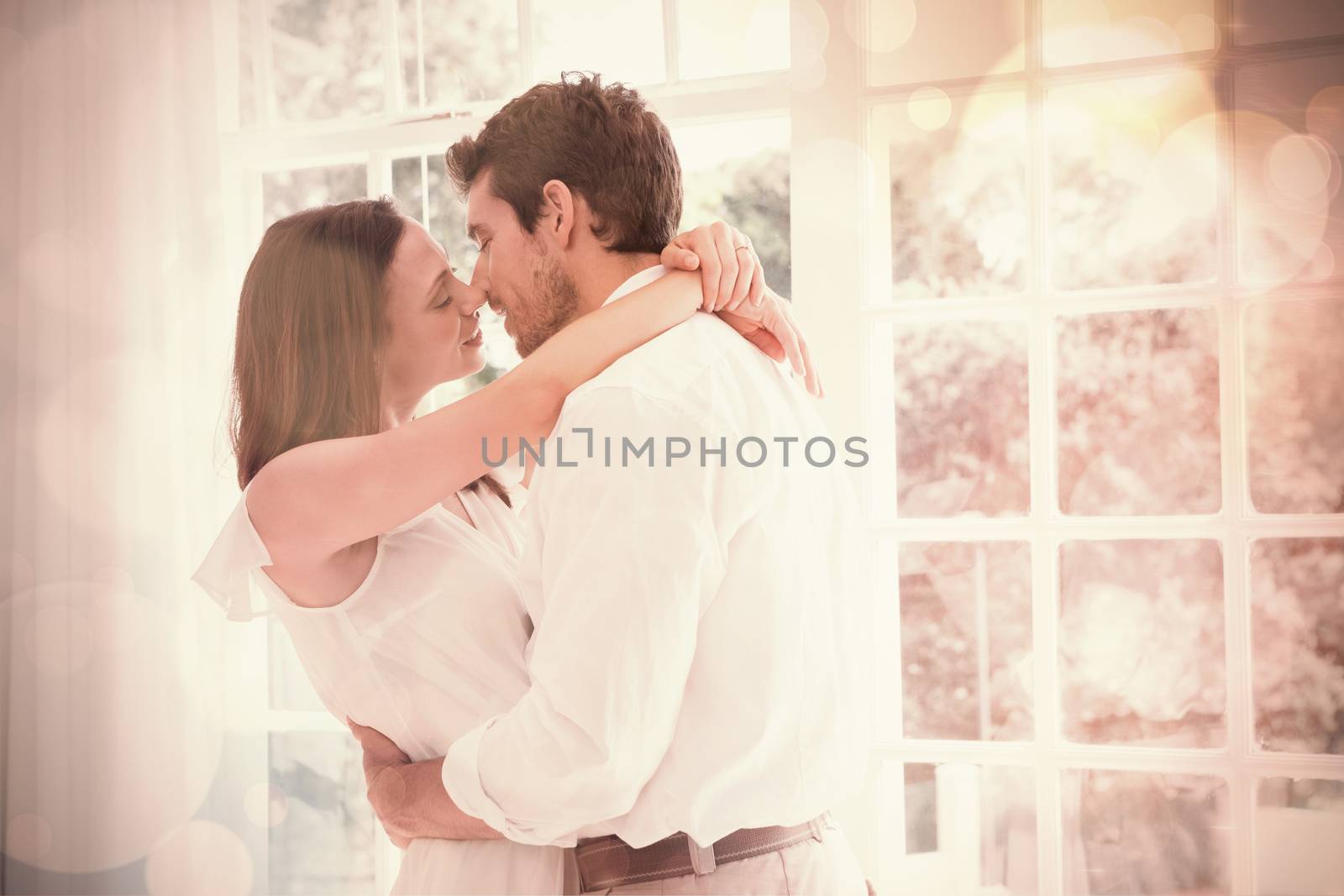 Side view of a loving young couple about to kiss at home