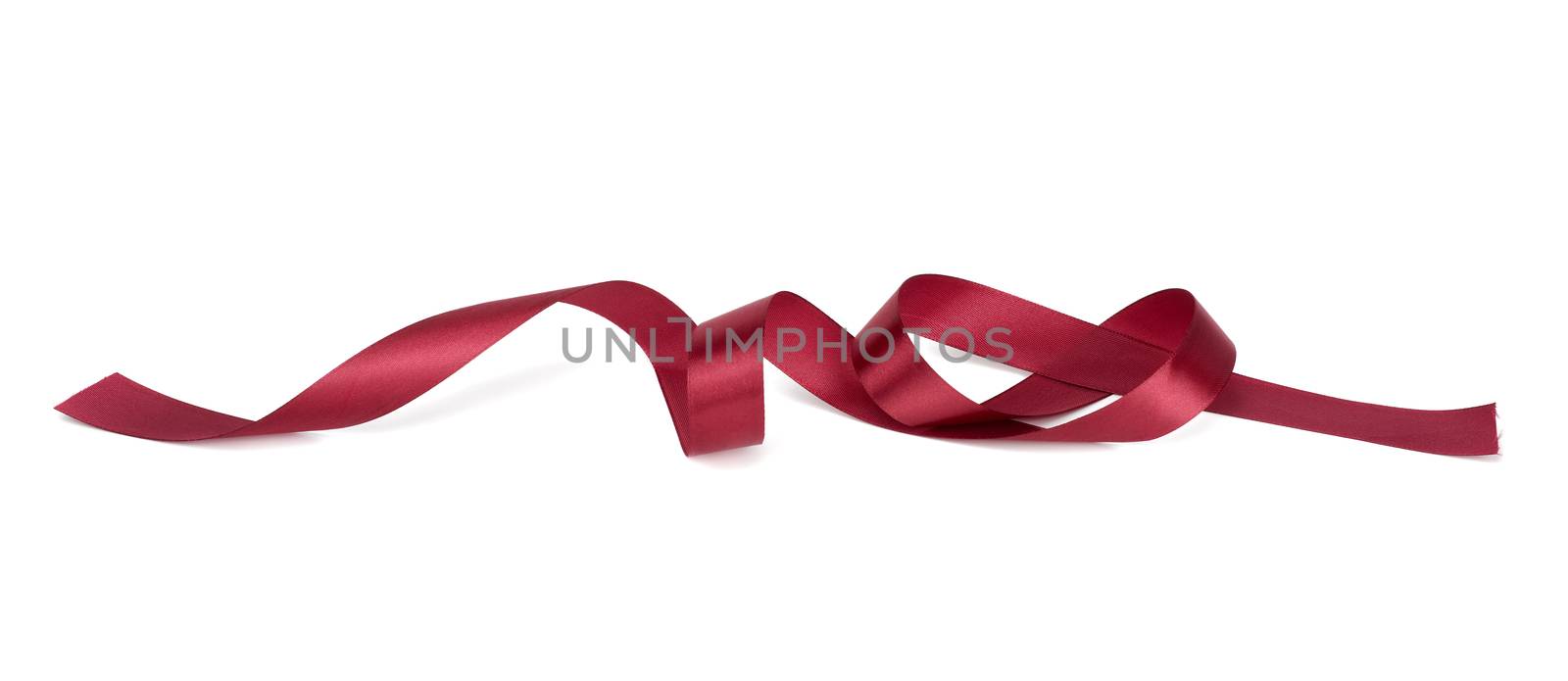 twisted red silk ribbon with bends isolated on white background, festive decor