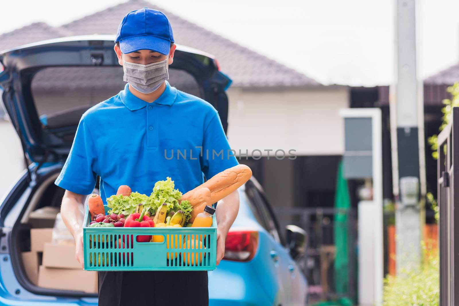 Delivery man wearing face mask protect he delivering fresh food  by Sorapop