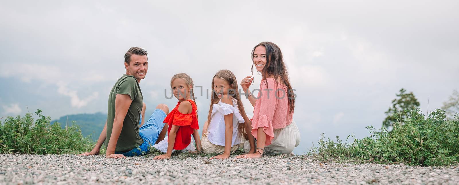 Beautiful happy family in mountains in the background of fog by travnikovstudio