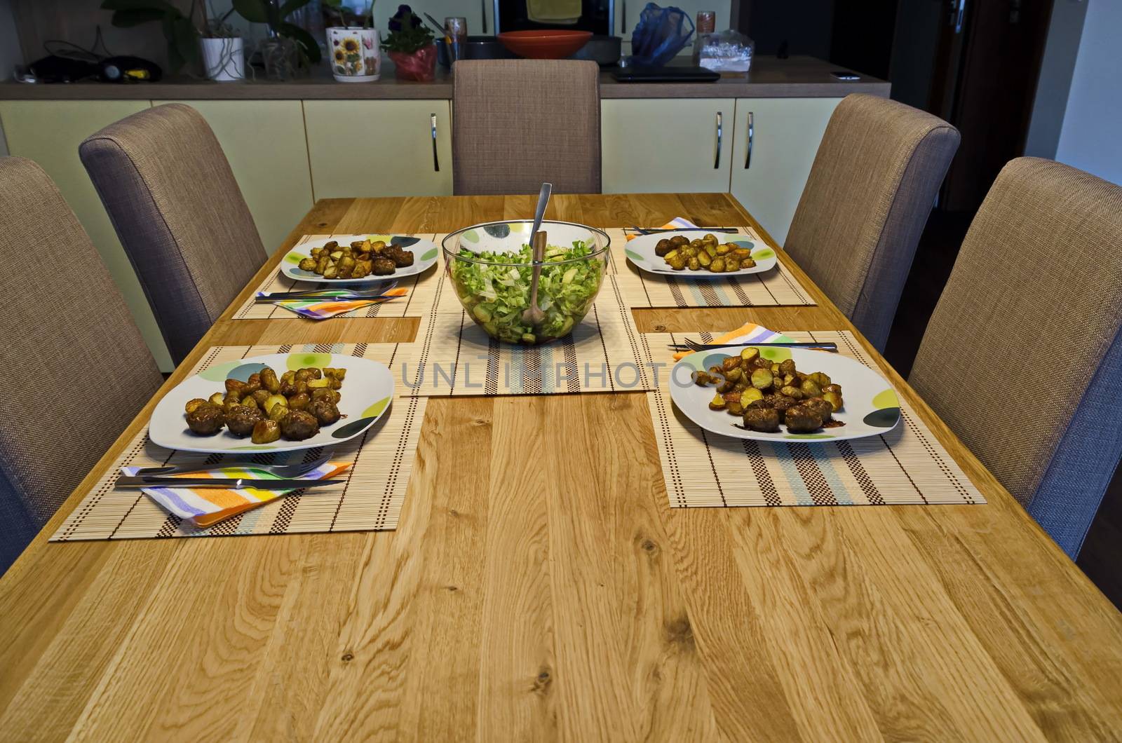 Served appetizing dinner of fried potatoes and green salad on a table, Sofia, Bulgaria