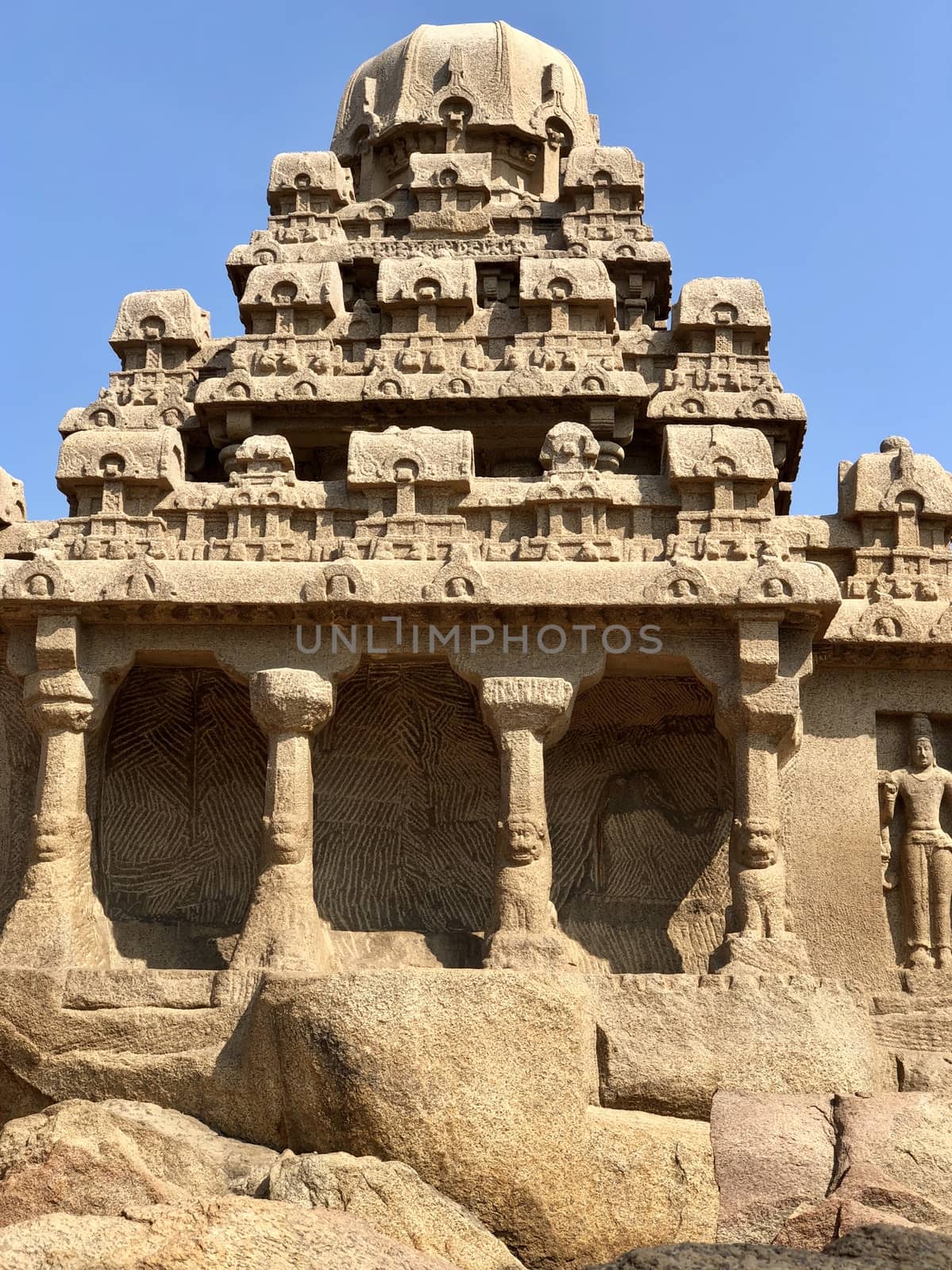 Dharmaraja Ratha is a monument in the Pancha Rathas is an example of monolith Indian rock-cut architecture. Resembling a chariot ratha, it is carved out of a single, long stone of pink granite. This is one of the Group of Monuments at Mahabalipuram and also a UNESCO World Heritage Site. The unfinished structure is dedicated to the Lord Shiva.