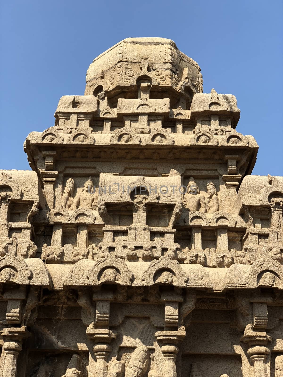 Dharmaraja Ratha is a monument in the Pancha Rathas is an example of monolith Indian rock-cut architecture. Resembling a chariot ratha, it is carved out of a single, long stone of pink granite. This is one of the Group of Monuments at Mahabalipuram and also a UNESCO World Heritage Site. The unfinished structure is dedicated to the Lord Shiva.