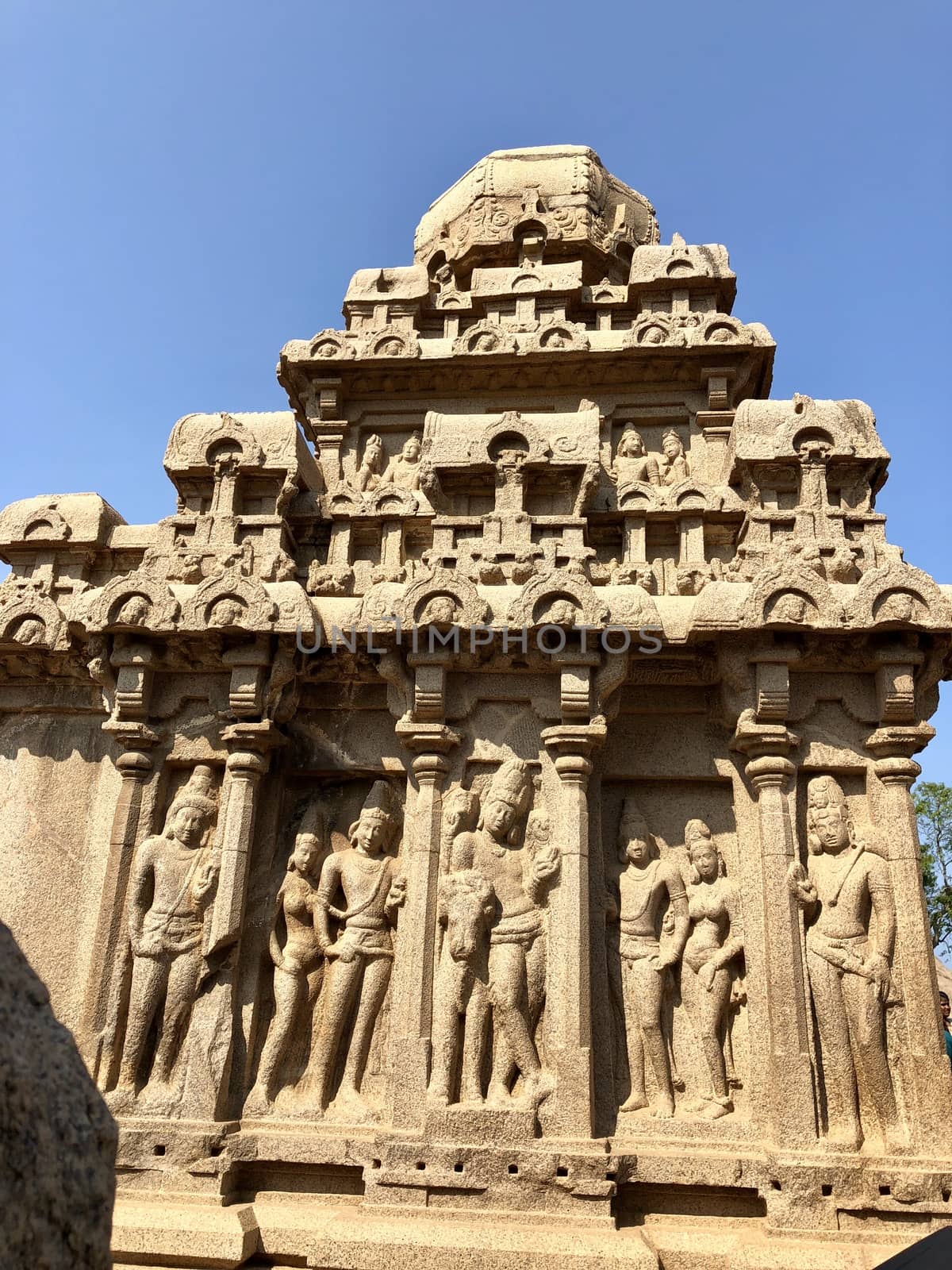 Dharmaraja Ratha is a monument in the Pancha Rathas is an example of monolith Indian rock-cut architecture. Resembling a chariot ratha, it is carved out of a single, long stone of pink granite. This is one of the Group of Monuments at Mahabalipuram and also a UNESCO World Heritage Site. The unfinished structure is dedicated to the Lord Shiva.