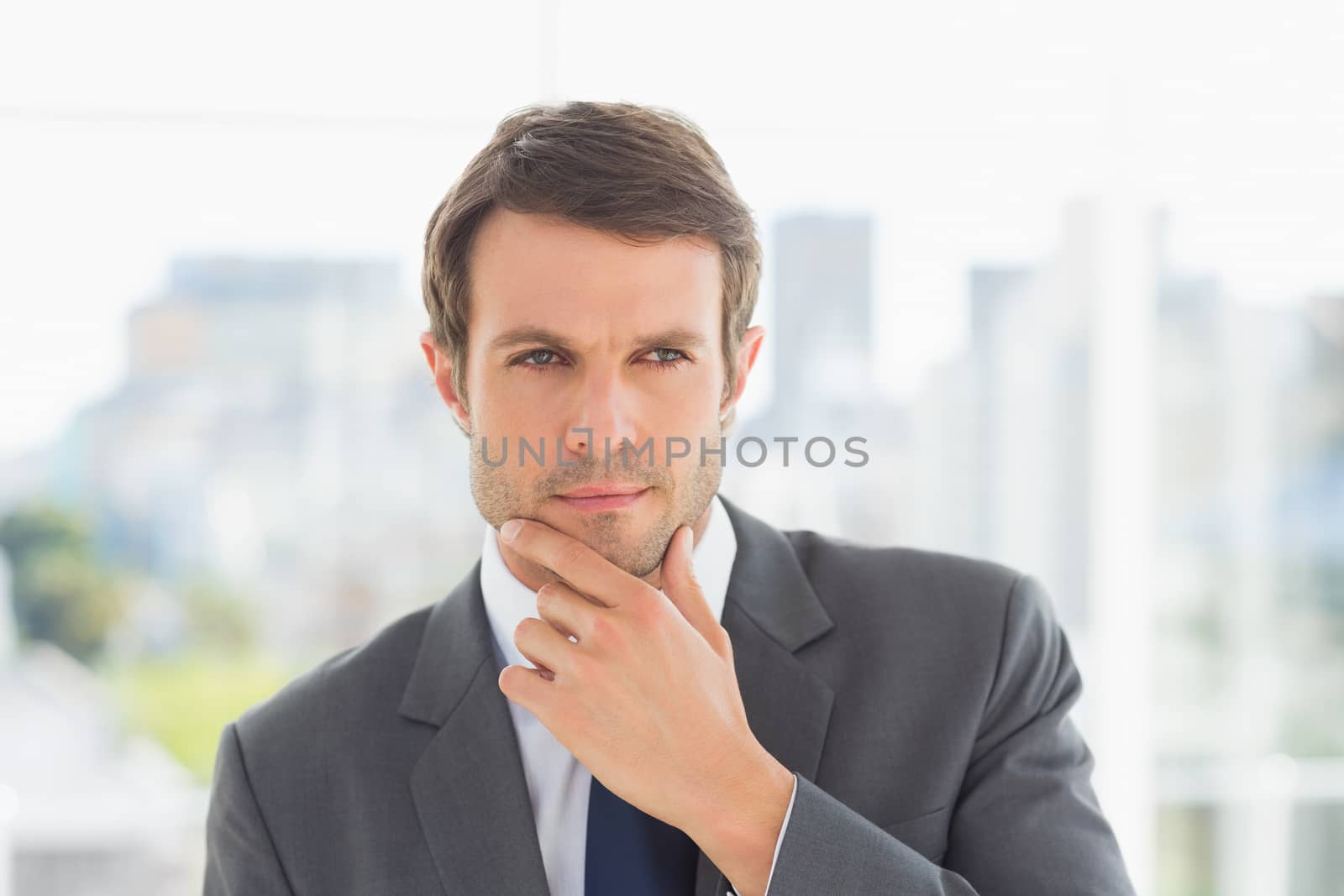 Closeup of a handsome young businessman over blurred background outdoors