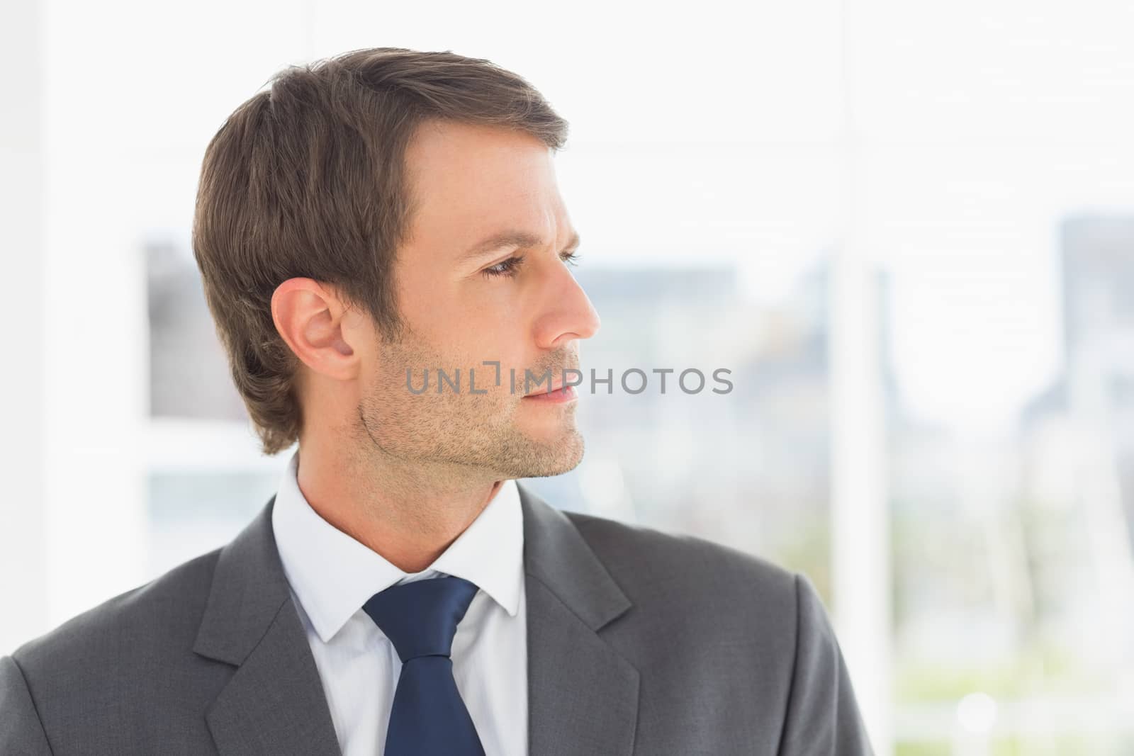 Closeup of a handsome young businessman over blurred background outdoors