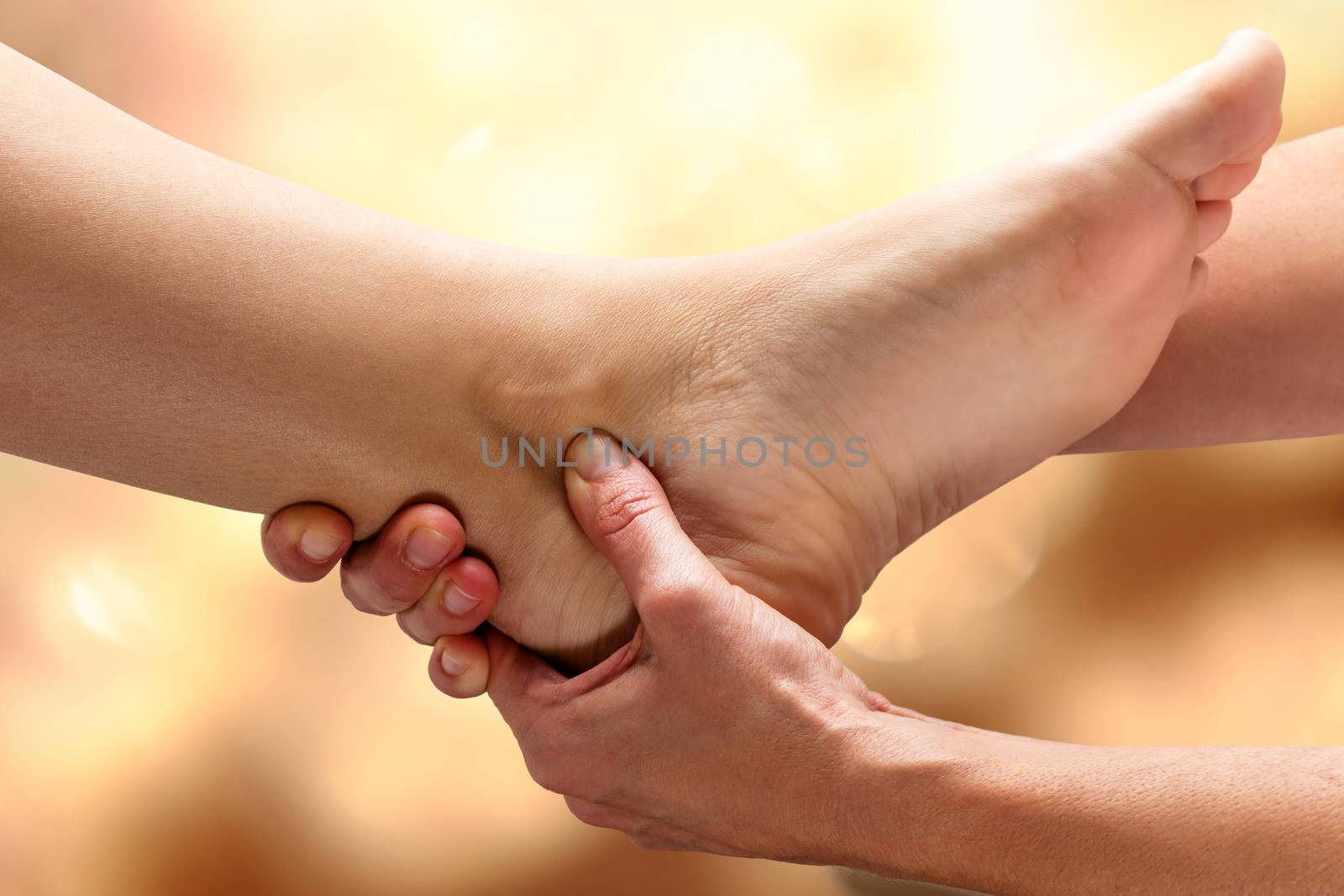 Close up of Kinesiologist doing therapy on female ankle.