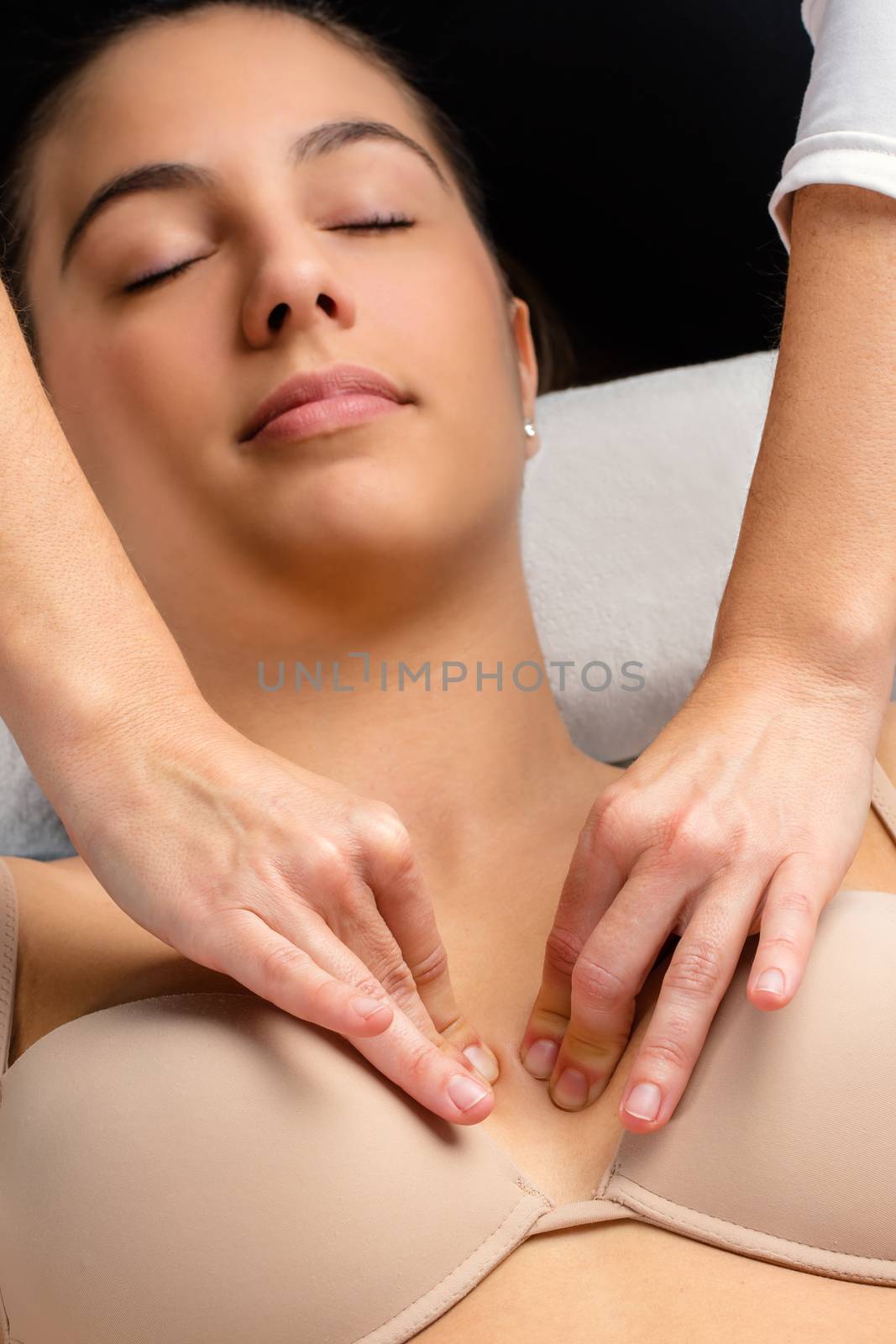 Top view of kinesiologist applying pressure on female chest.