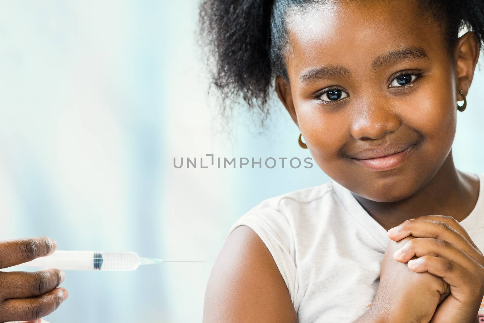 Brave little african girl at doctor's practice. by karelnoppe