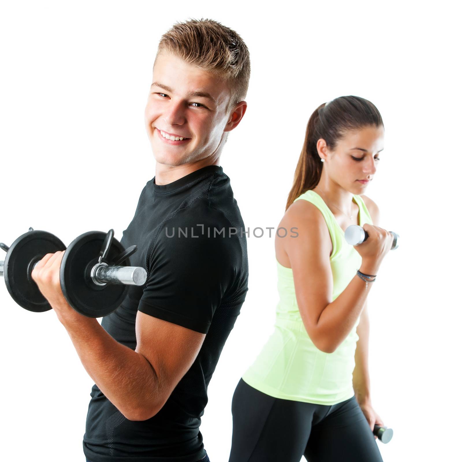 Close up portrait of handsome teen boy working out with weights.Out of focus girl working out in background.Isolated on white.