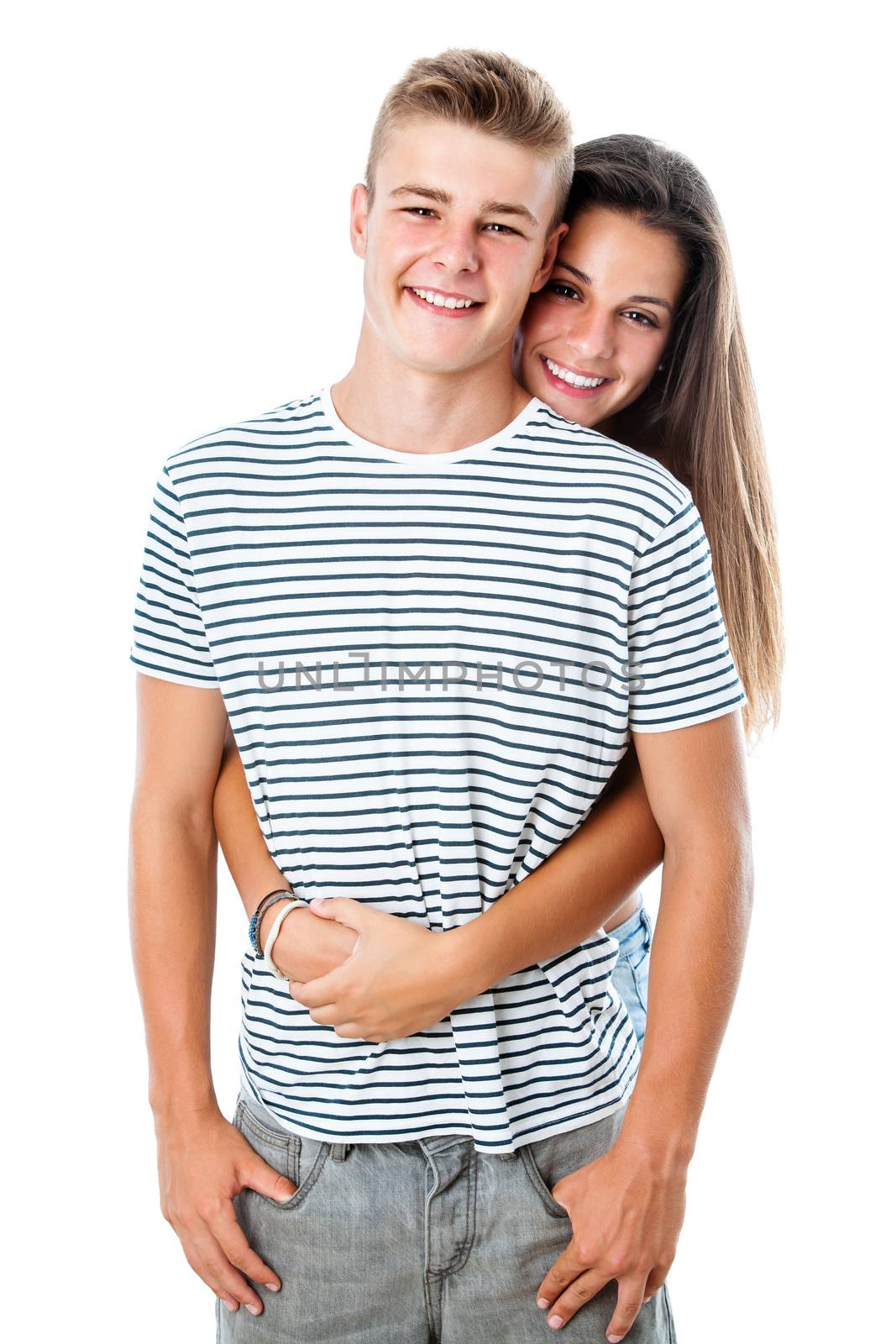 Close up portrait of handsome teen boy with girlfriend embracing from behind.Isolated on white background.