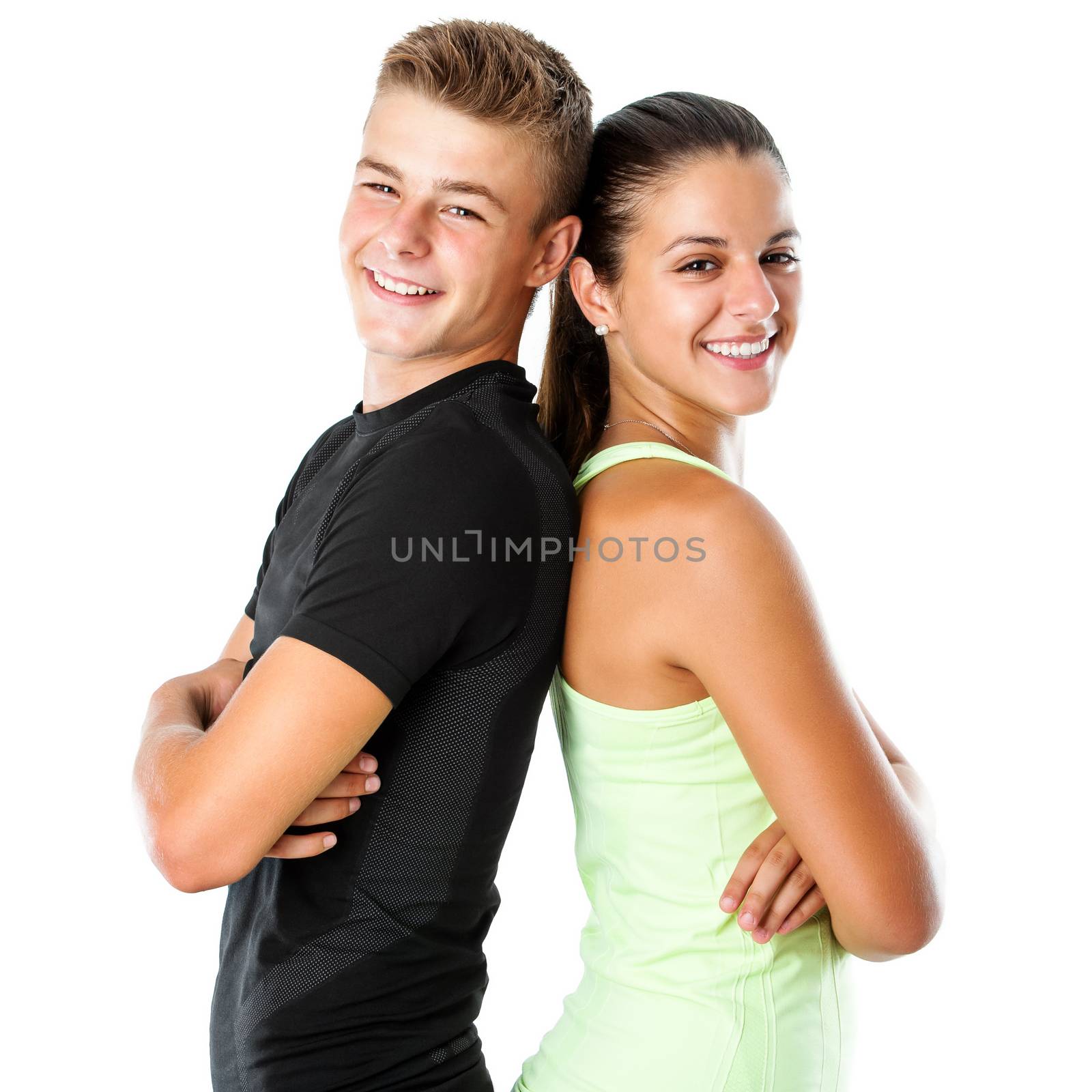 Close up portrait of attractive teen couple in sportswear standing back to back.Isolated on white background.