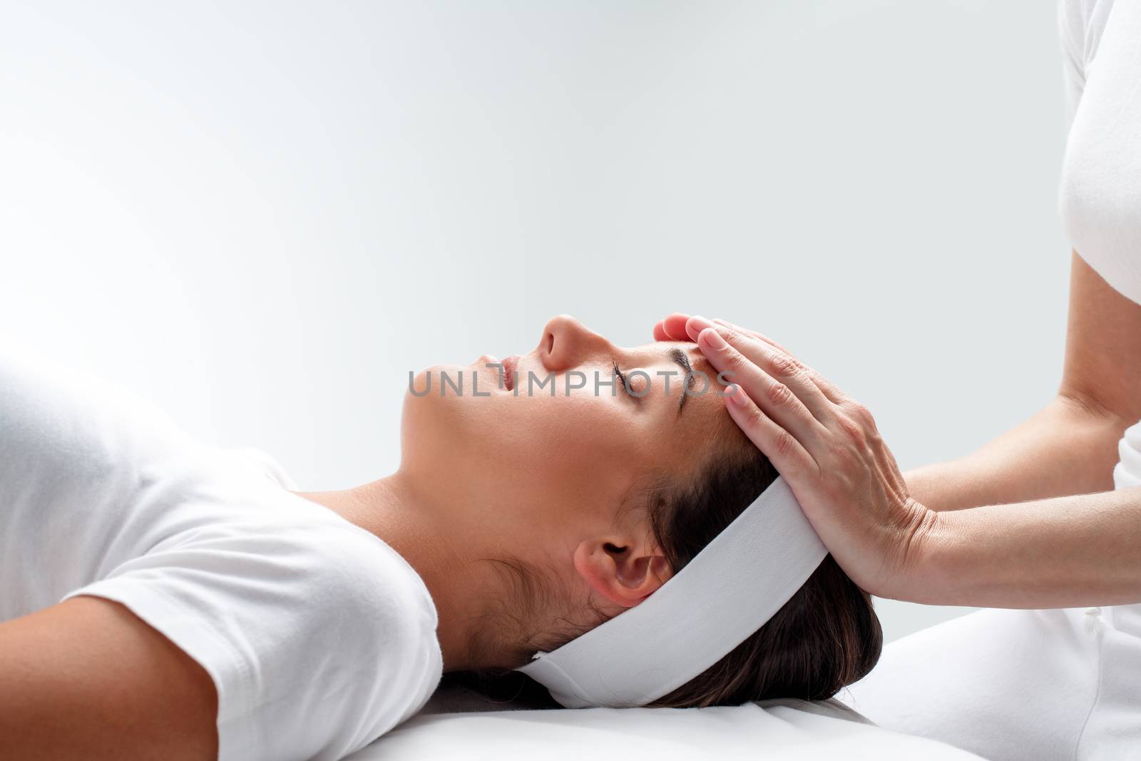Woman relaxing at reiki session. by karelnoppe