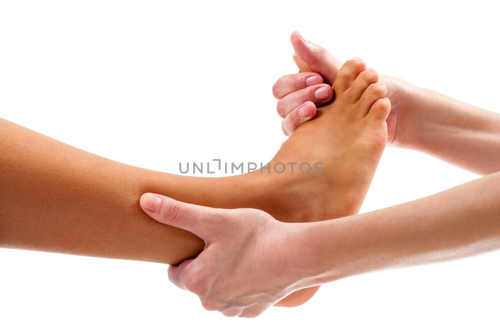 Extreme close up osteopath doing reflexology massage on female foot. Isolated on white background background.