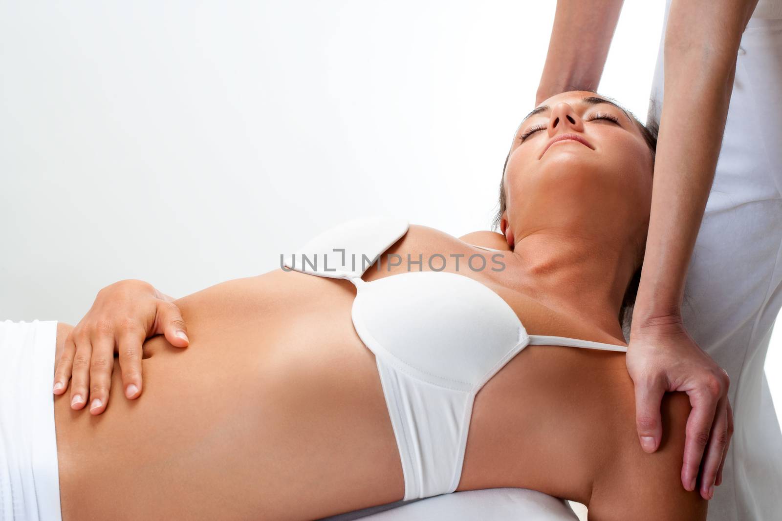 Woman having healing massage. by karelnoppe