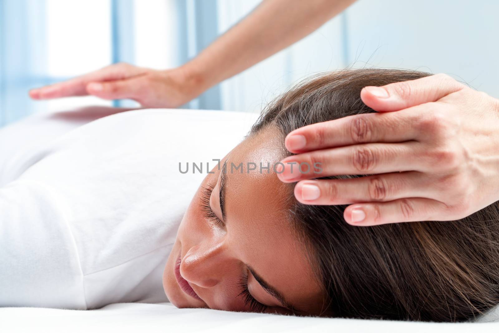 Therapists hands doing reiki therapy on girl. by karelnoppe