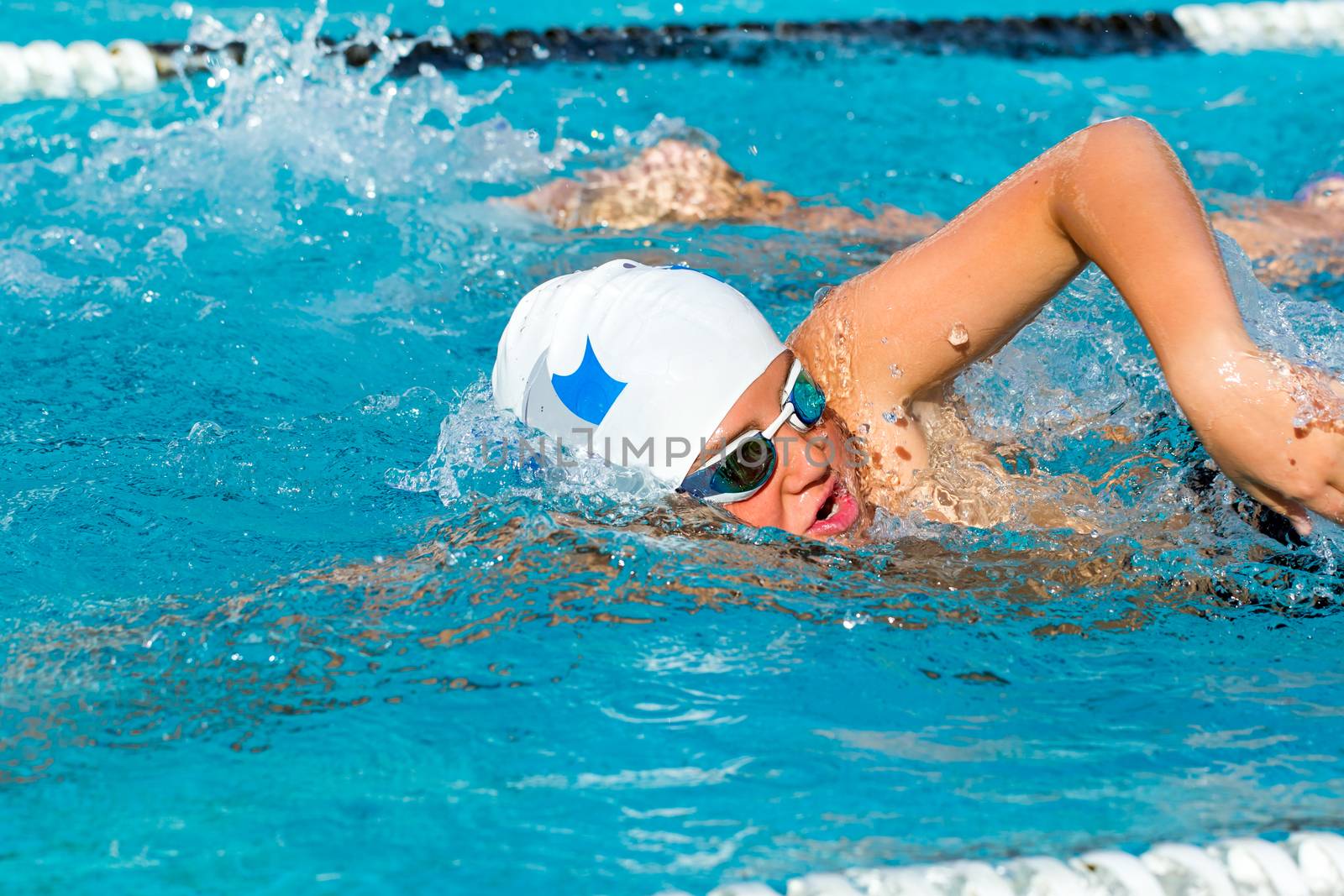 Young male swimmer competing in gala. by karelnoppe