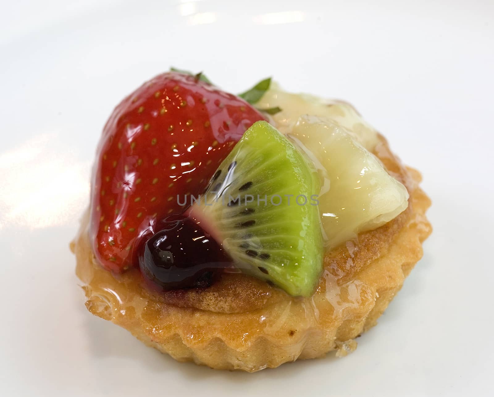 Mini fruit cake with fresh berries. Close up view.