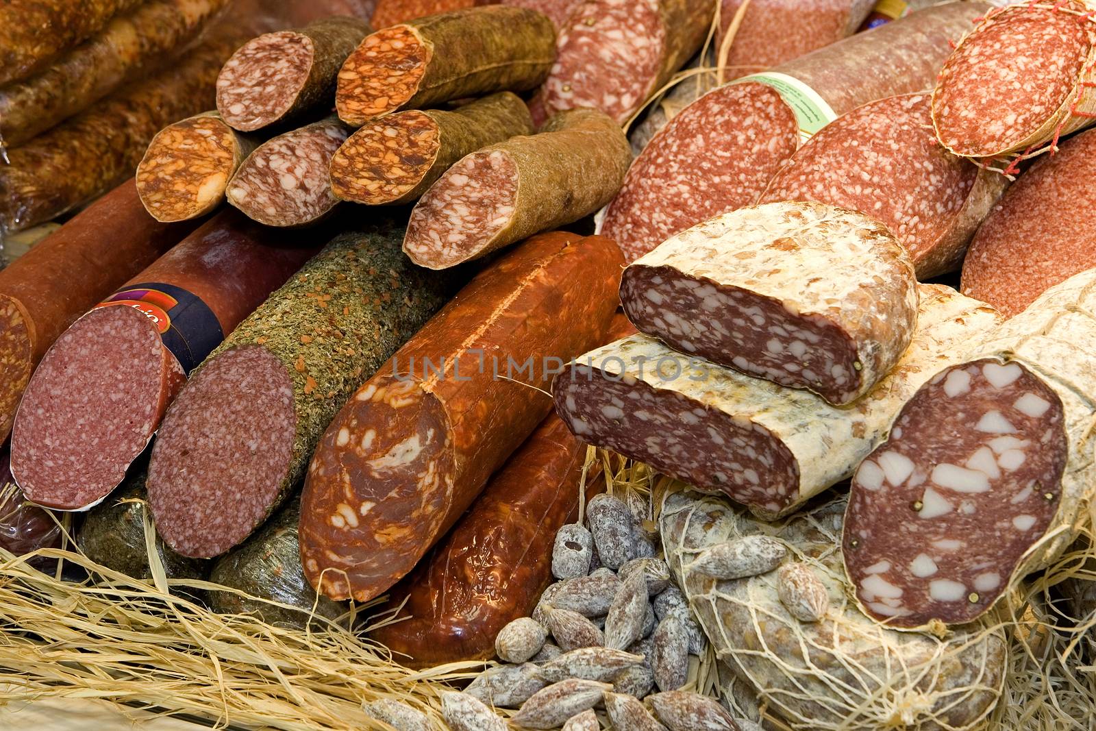 Different types of raw smoked sausage on the store shelf.