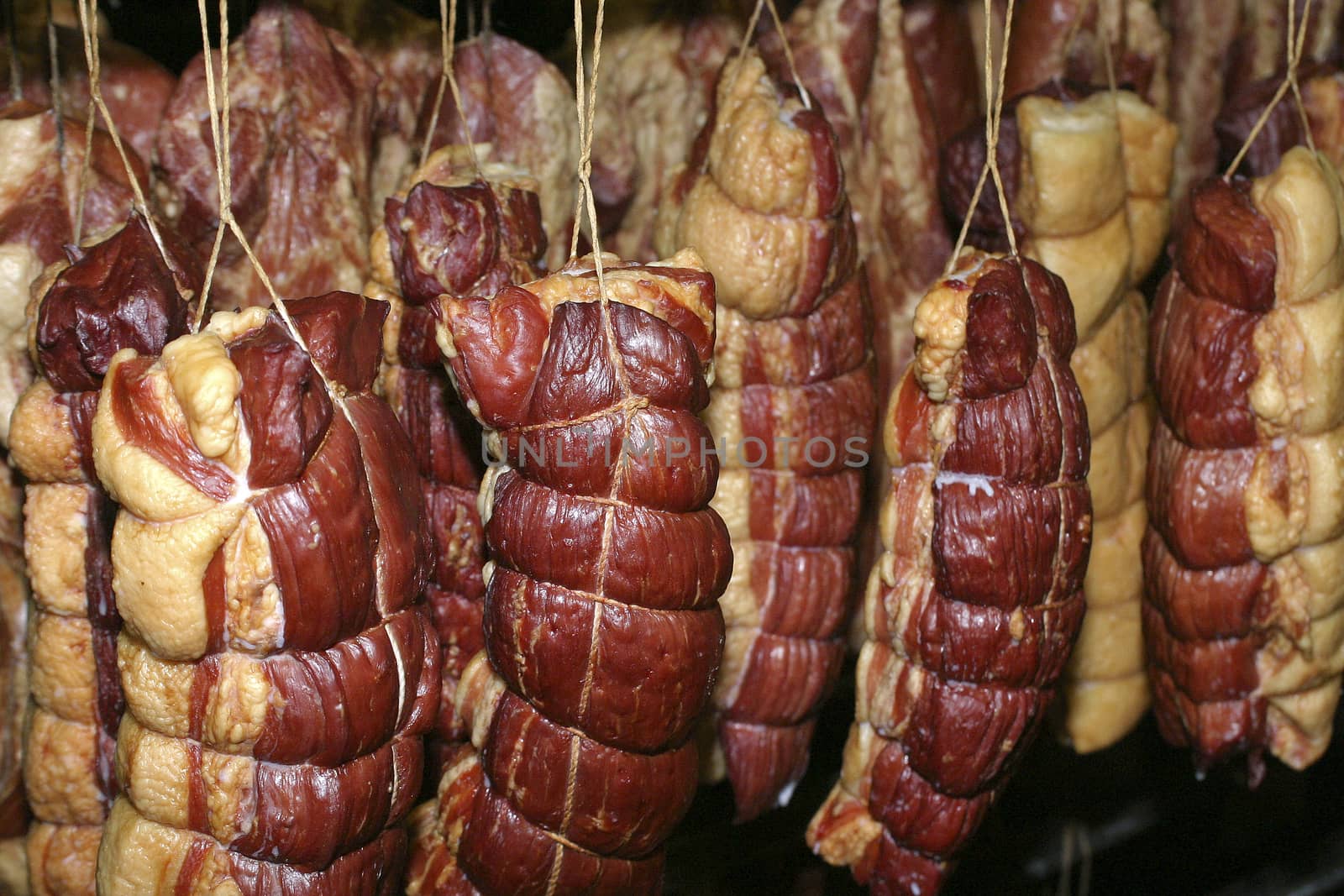 Smoked meat production line. Meat on the counter for the smokehouse.