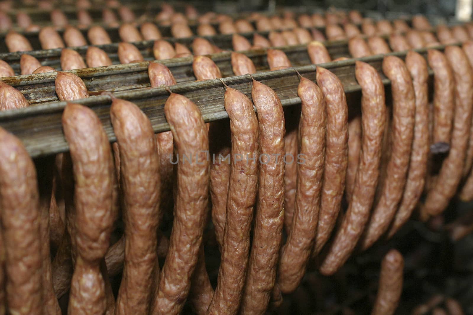 Sausage production line. Sausage on the counter for the smokehouse. Industrial manufacture of sausages.