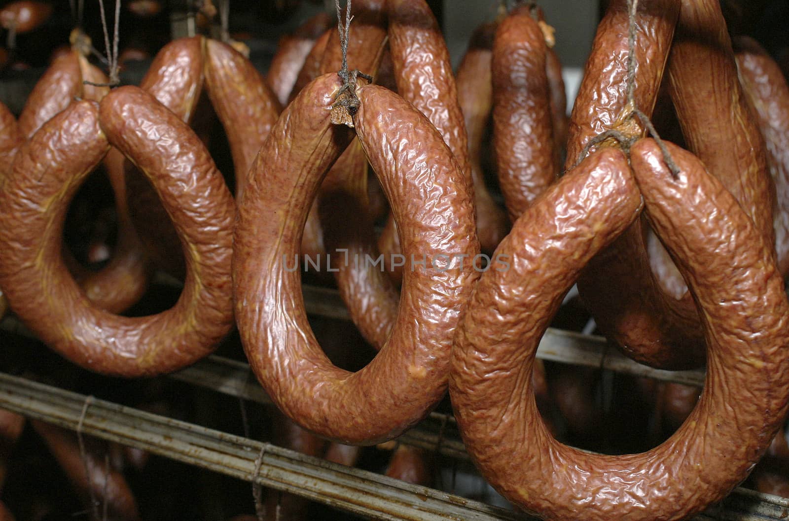 Sausage production line. Sausage on the counter for the smokehouse. Industrial manufacture of sausages.