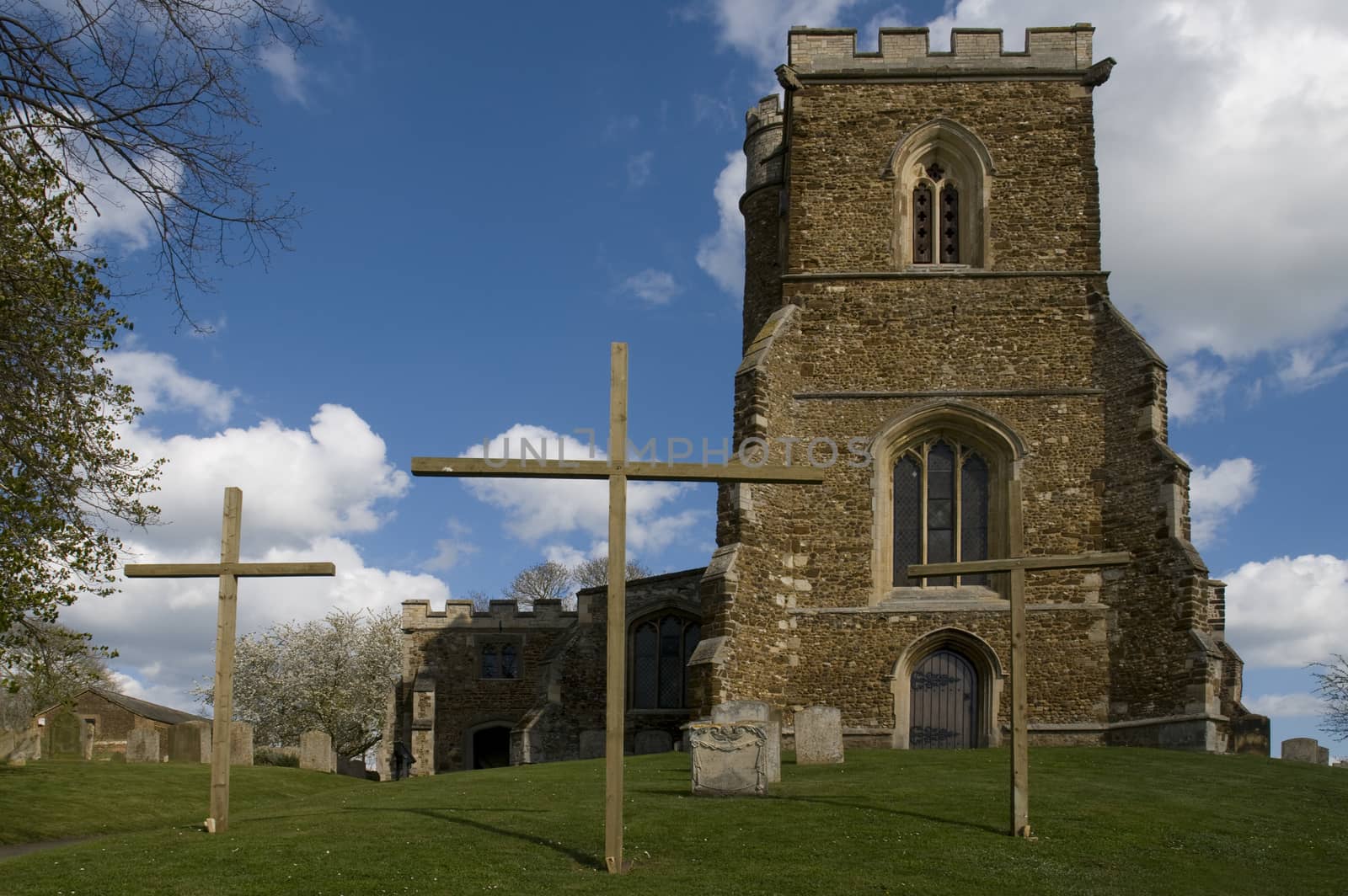 An English Parish Church with 3 crosses outside at Easter time