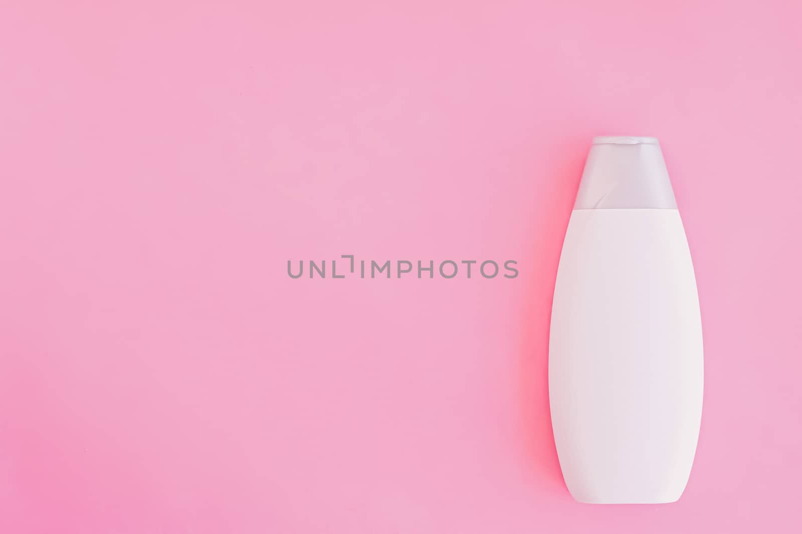 Blank label shampoo bottle or shower gel on pink background, beauty product and body care cosmetics, flatlay