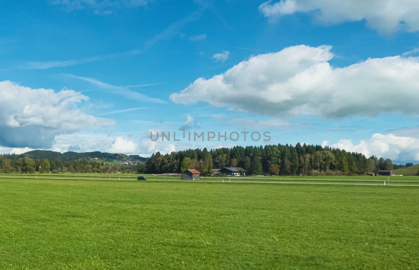 Beautiful nature of European Alps, landscape view of alpine mountains, lake and village on a sunny day, travel and destination scenery