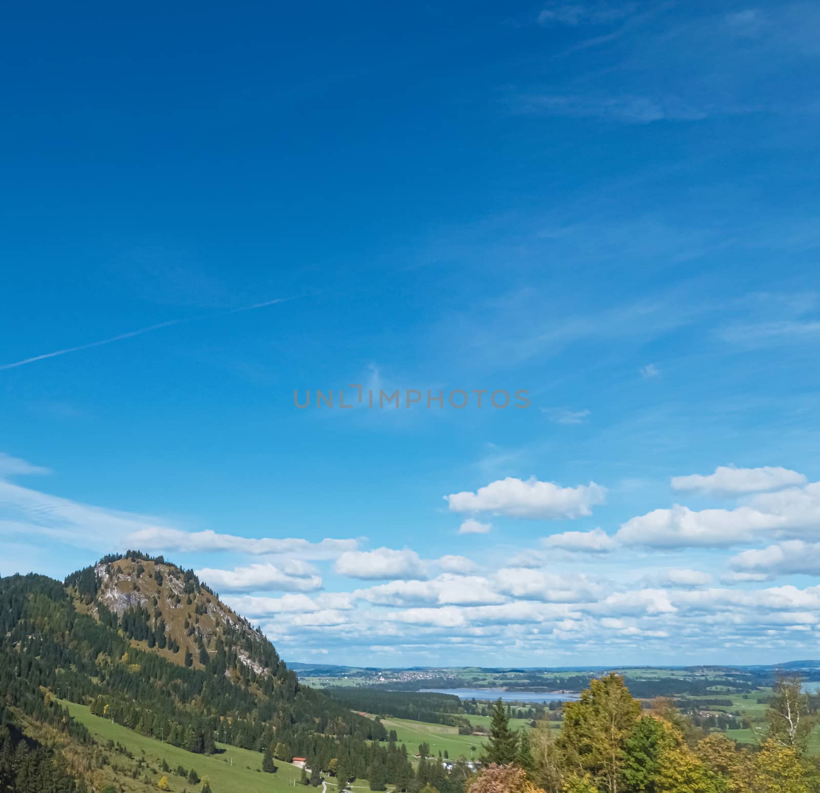 Beautiful nature of European Alps, landscape view of alpine mountains, lake and village on a sunny day, travel and destination scenery
