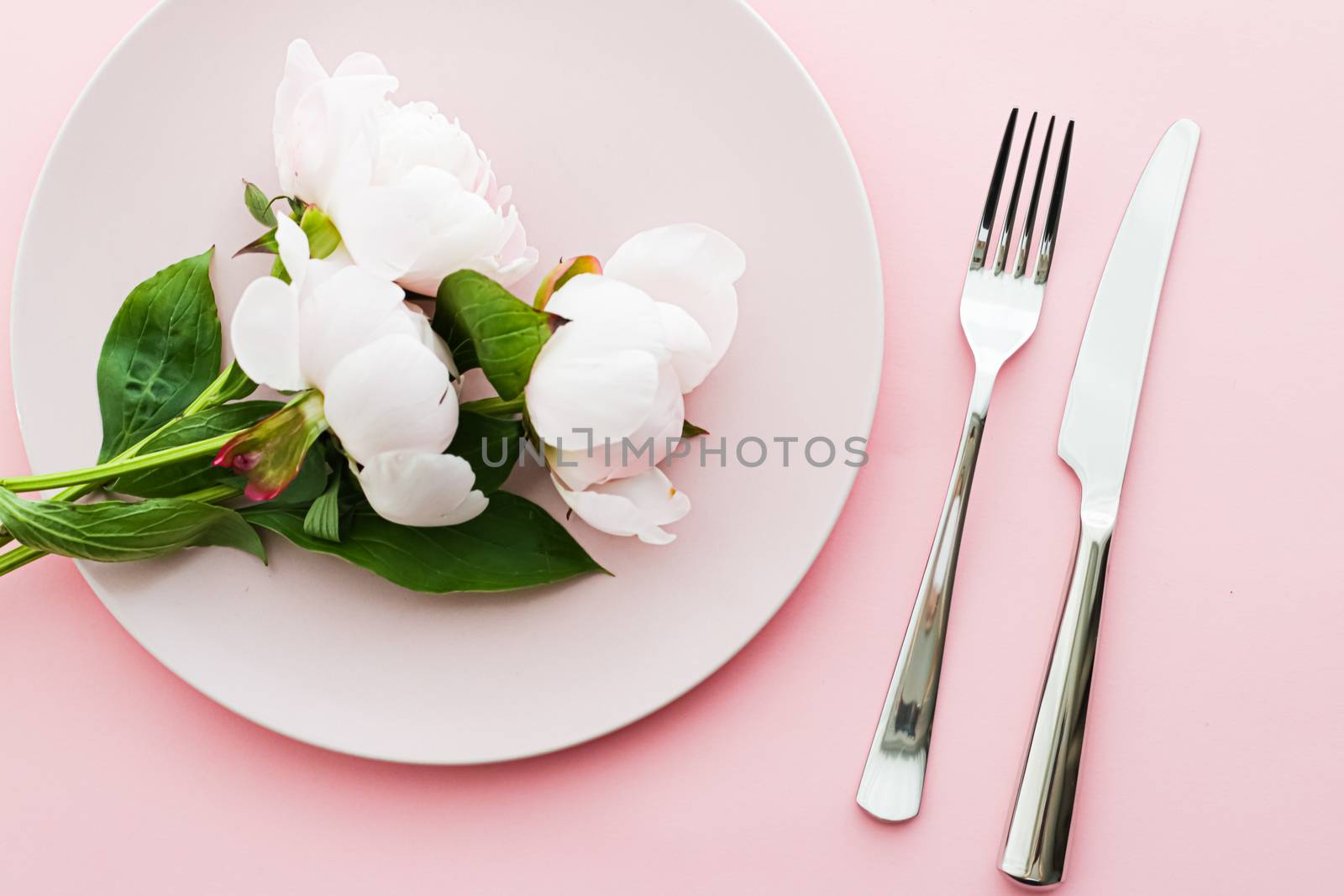 Dining plate and cutlery with peony flowers as wedding decor set on pink background, top tableware for event decoration and menu branding design