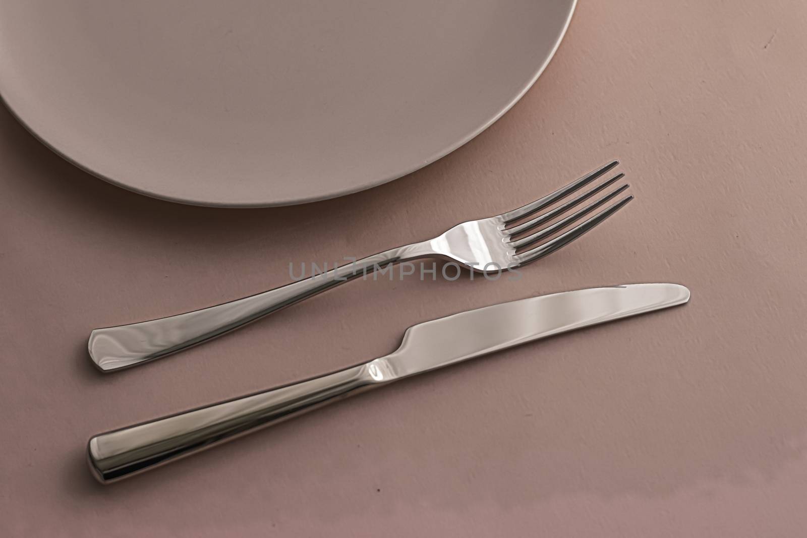 Empty plate and cutlery as mockup set on brown background, top tableware for chef table decor and menu branding design