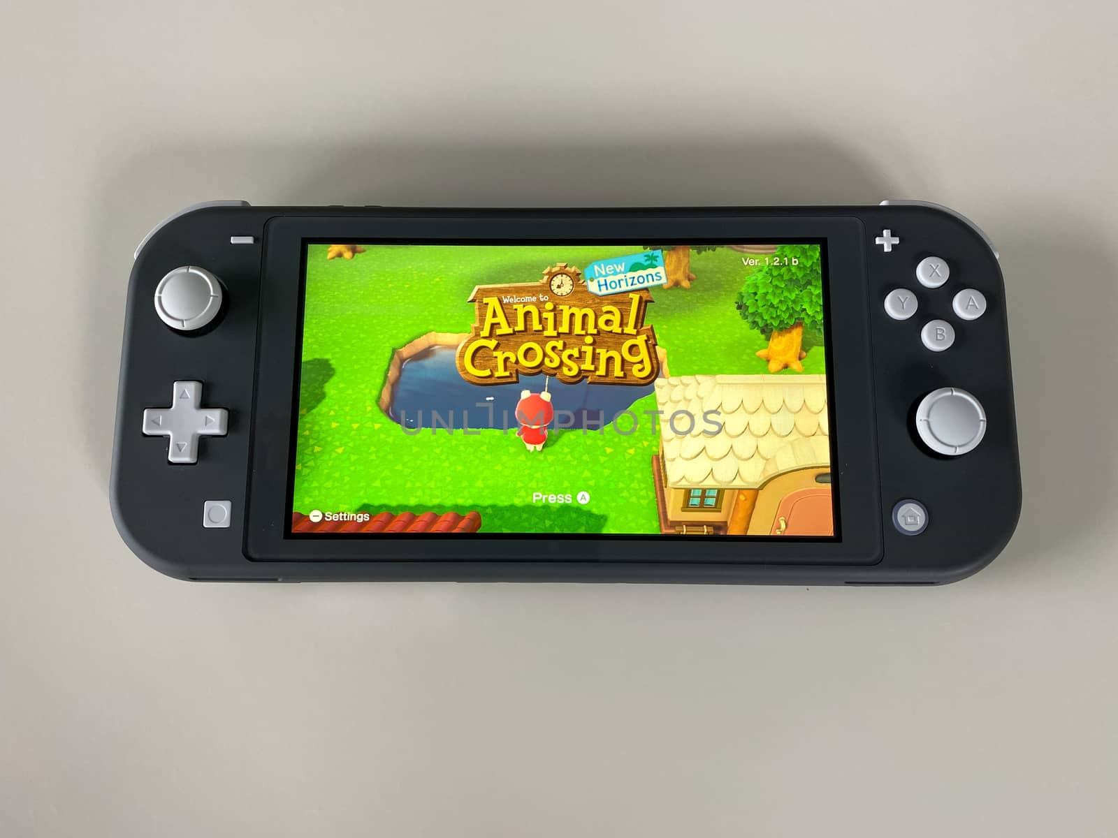 A Nintendo Switch Lite with the game Animal Crossing New Horizon by Jshanebutt